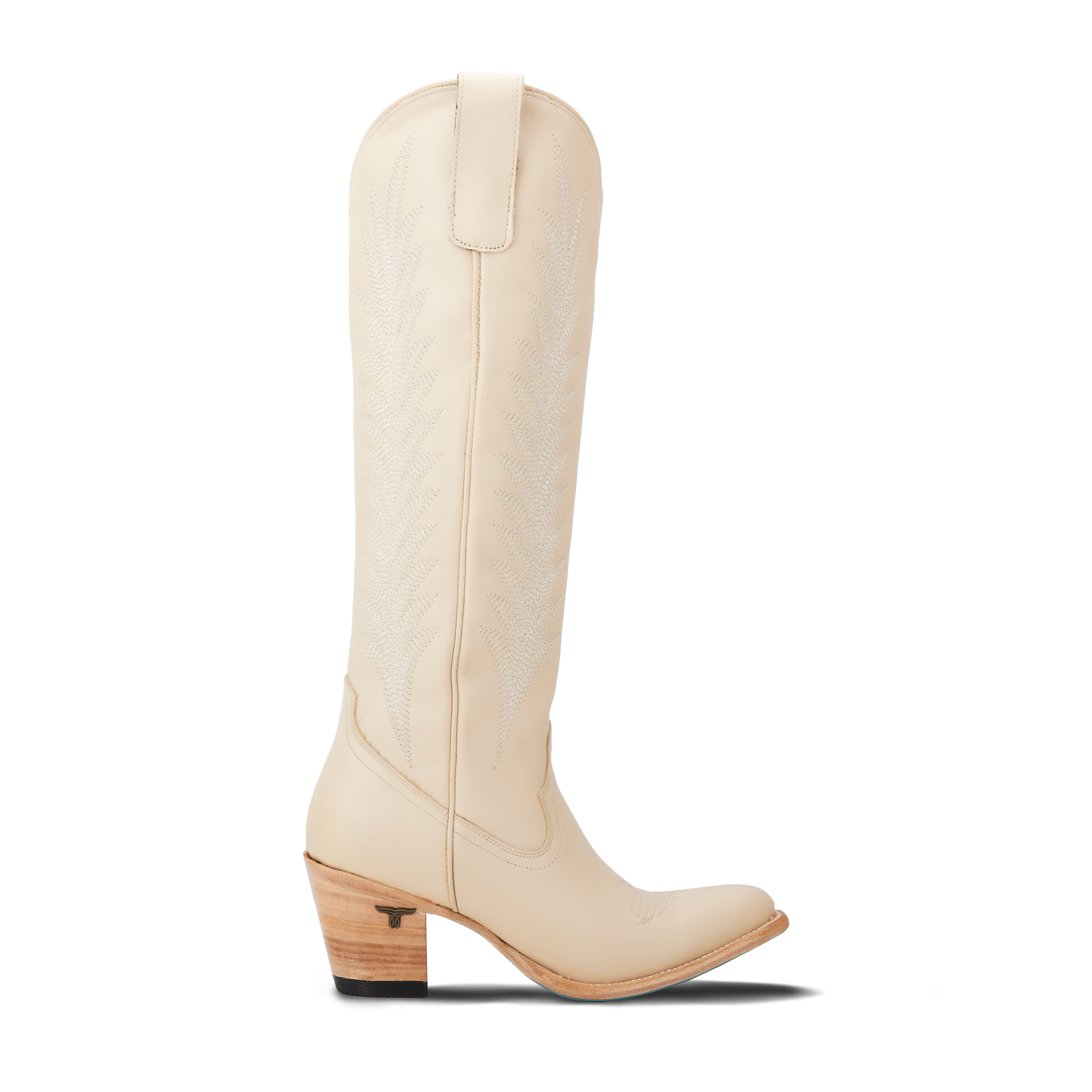 Side view of a tall cream colored cowboy boot with decorative stitching on the shaft, pull tabs at the top, a pointed toe, and a stacked heel