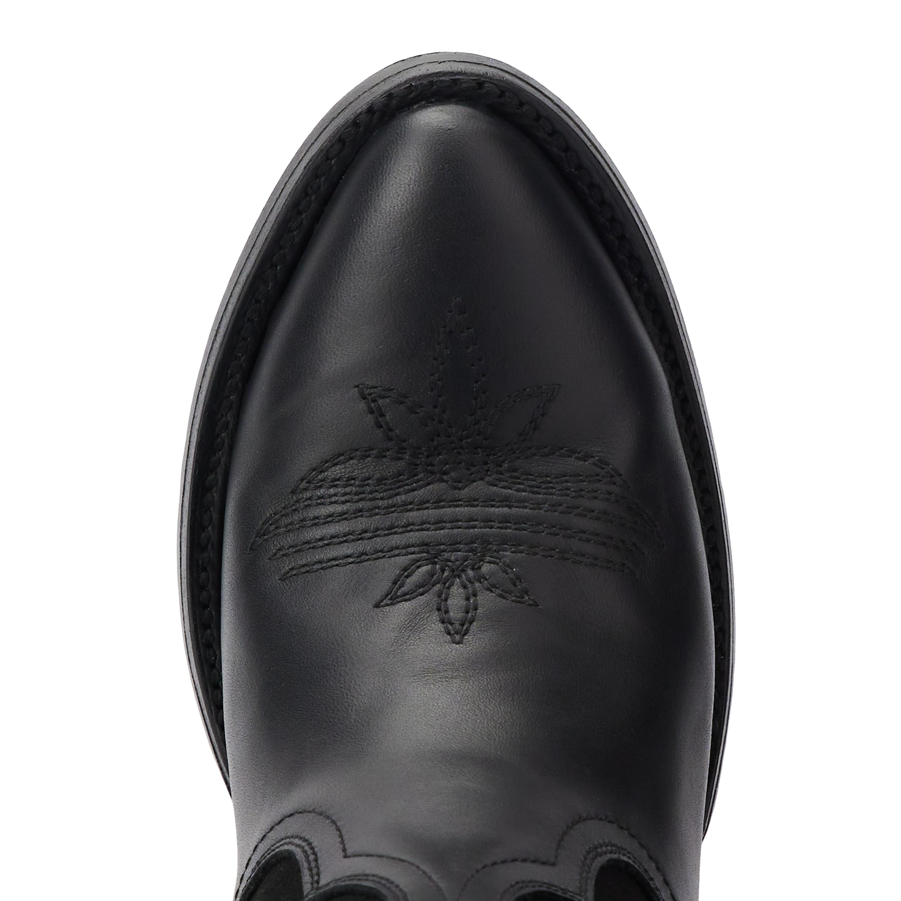 Close-up top view of a black cowboy boot toe with intricate stitched floral and curved line patterns, framed by black welt stitching