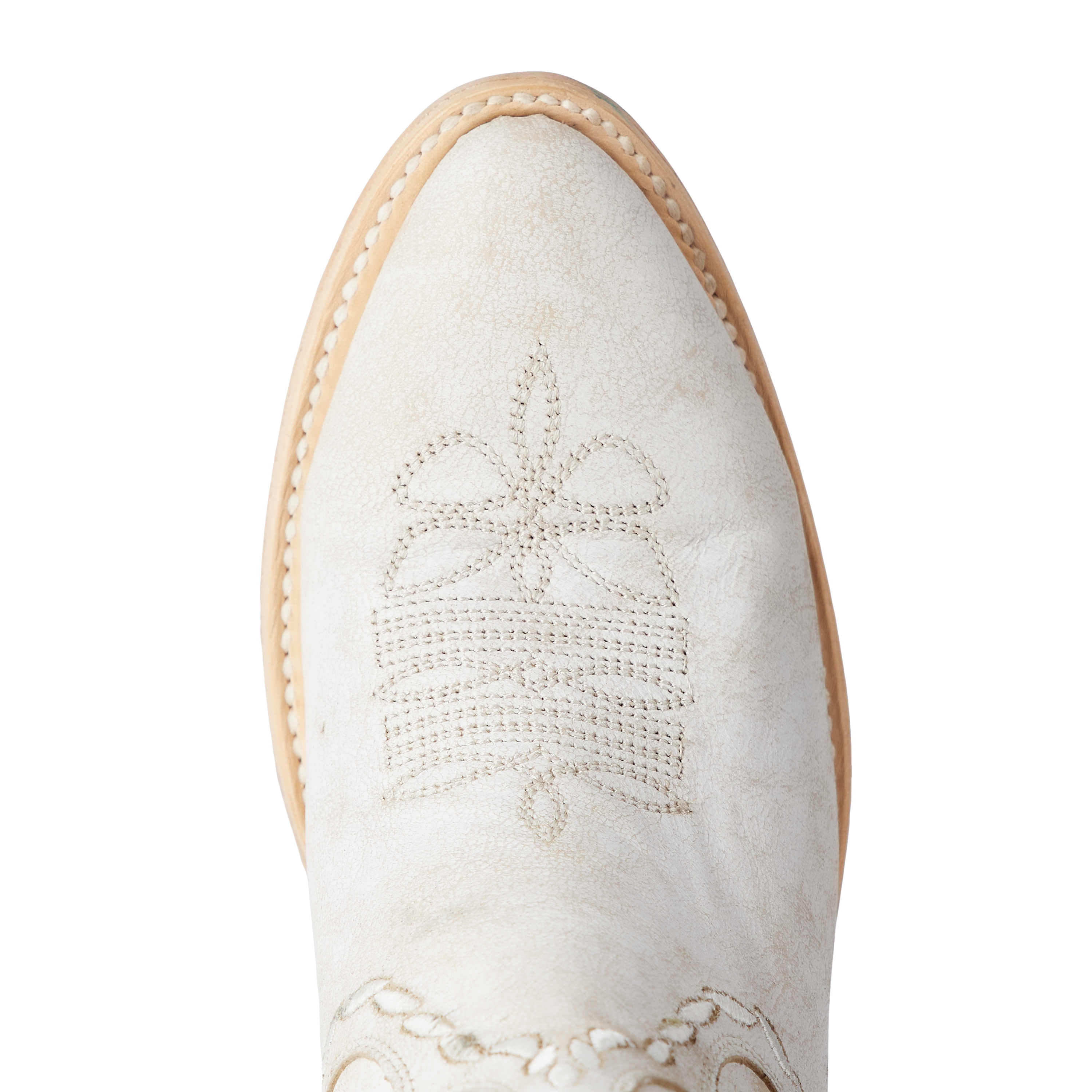 Close-up of a white cowboy boot toe with decorative stitching in a starburst pattern and a light-colored welt