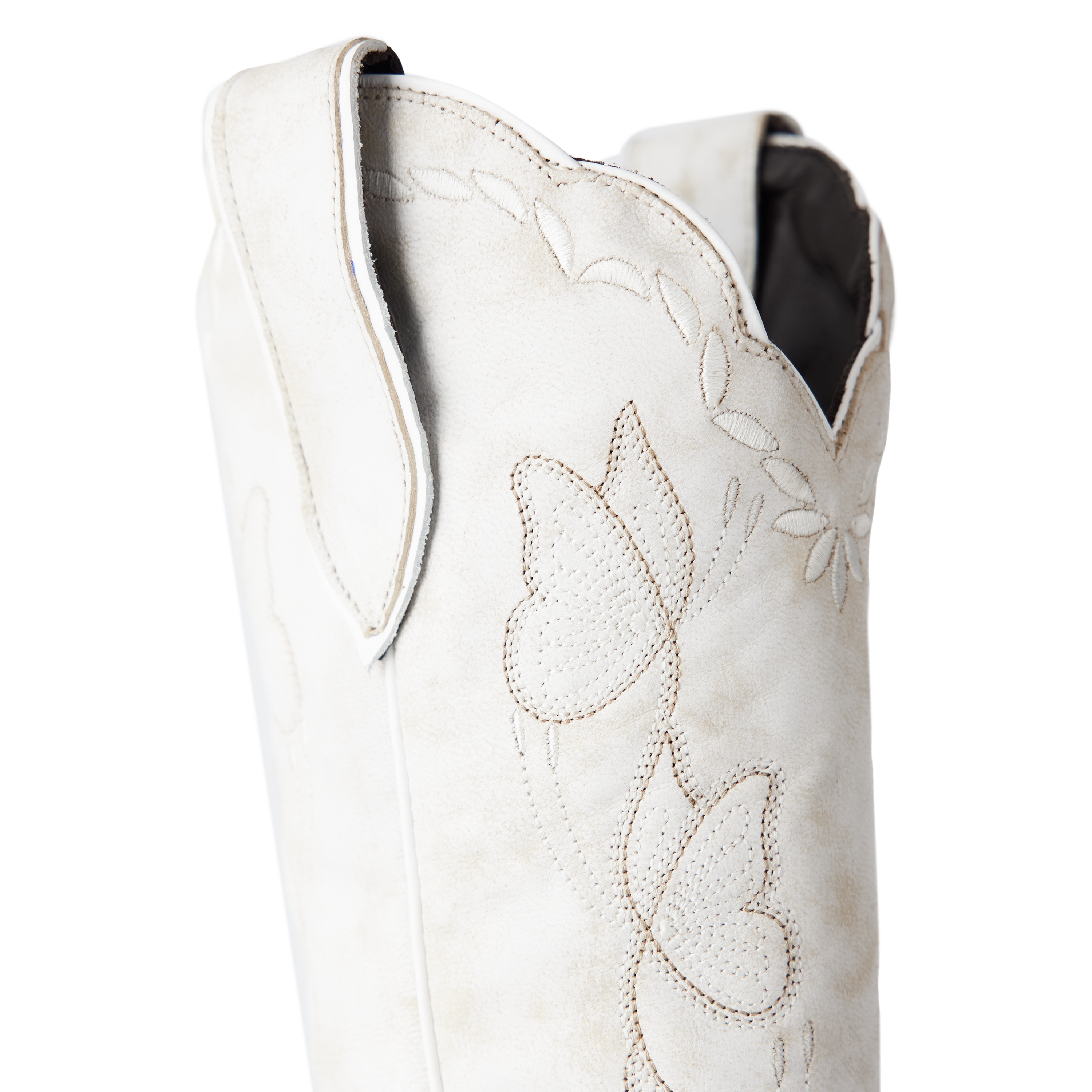 Close-up of the upper shaft of a white cowboy boot with floral stitching, scalloped edges, and a pull strap