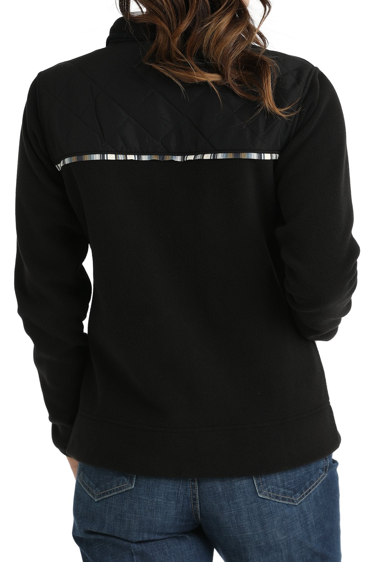 Back view of a woman wearing a black Cinch jacket with western trim accents and jeans