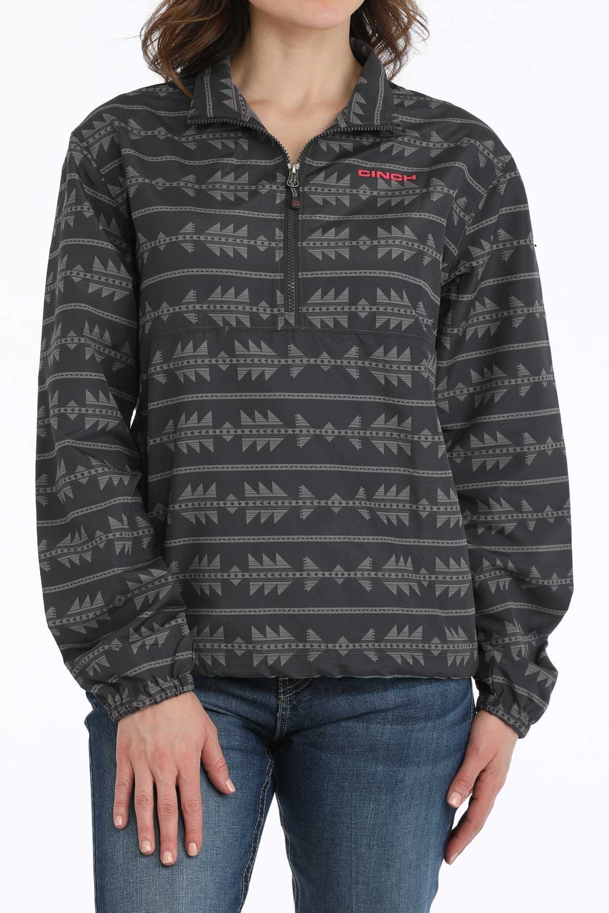 Person wearing a patterned pullover with a visible brand logo on a white background