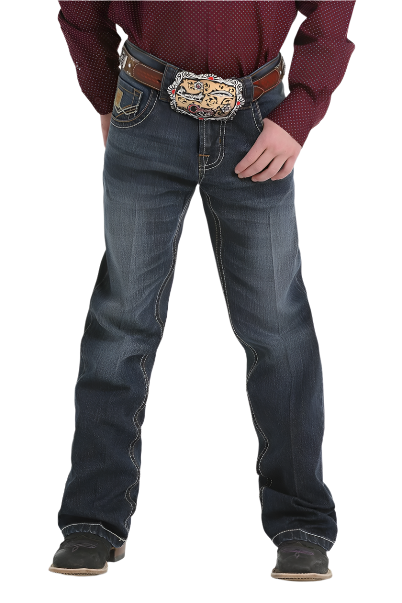 Boy wearing dark wash jeans and boots with a maroon long sleeve shirt and western belt