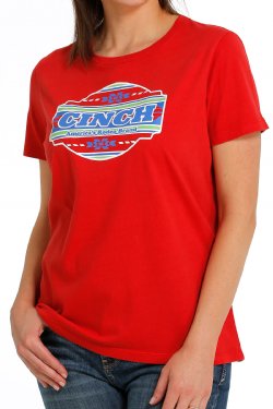 Front view of a woman wearing a red t-shirt with a large 'Cinch' graphic in the middle  and jeans