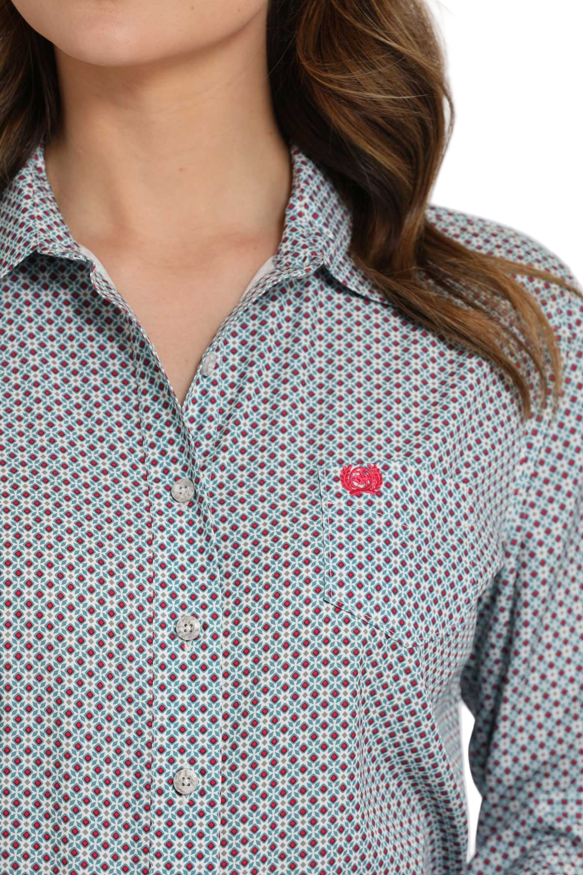 Close-up of a woman wearing a light patterned long-sleeve button shirt