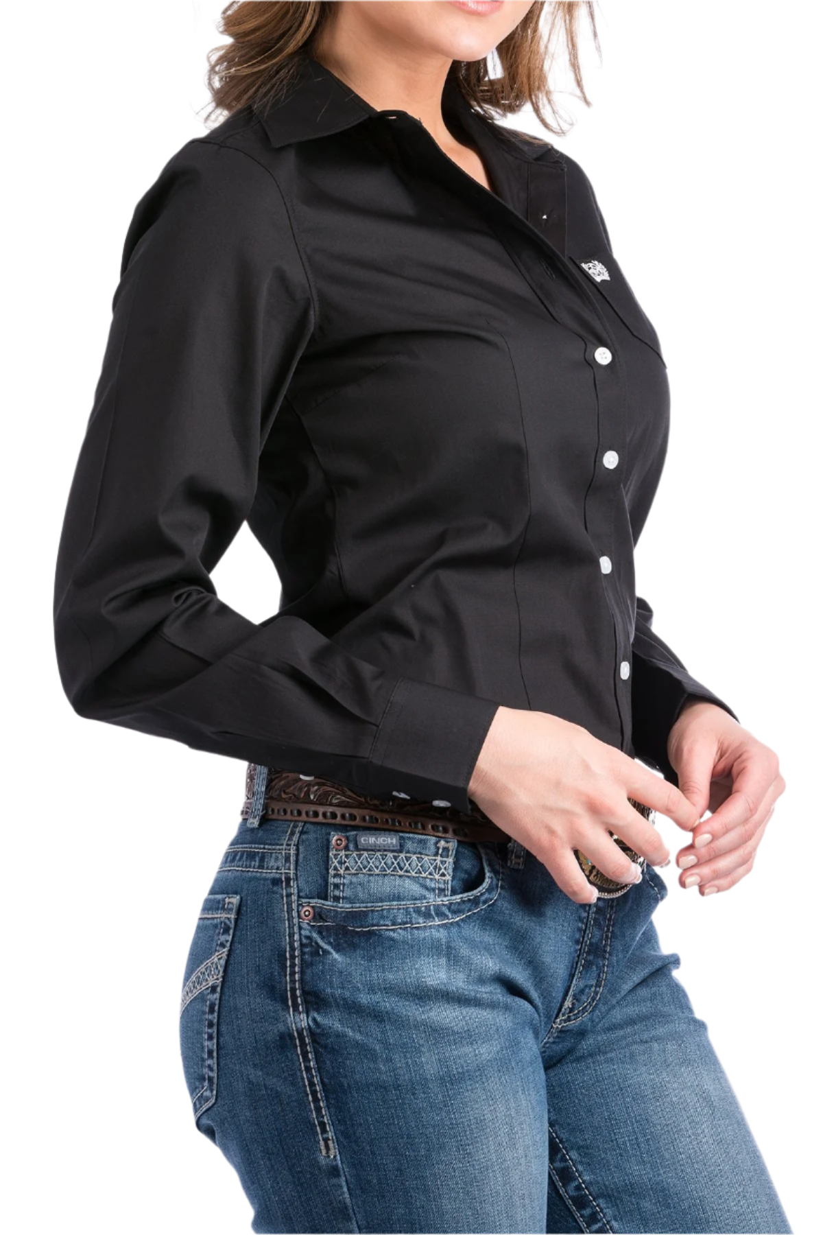 Woman wearing a black button down shirt with jeans and a western belt