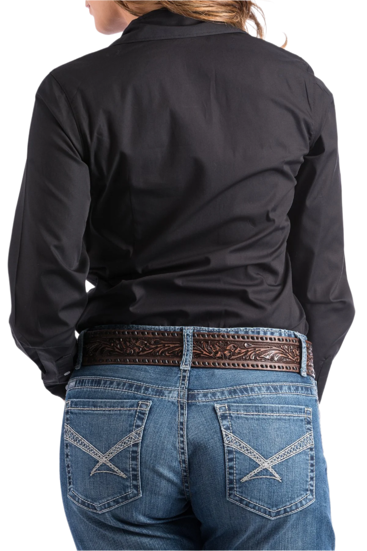 Back view of a woman wearing a black button down shirt with jeans and a western belt