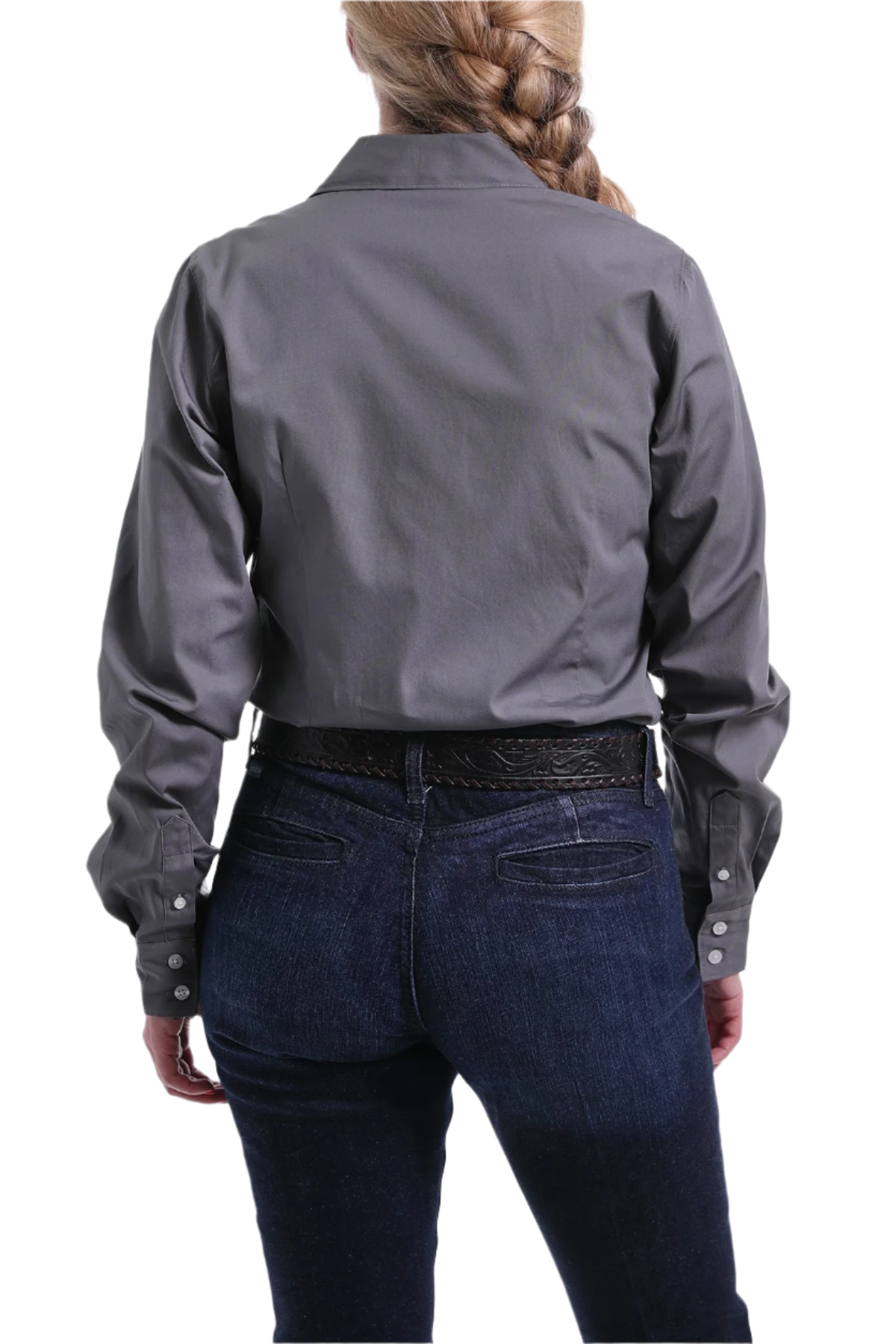 Back view of a woman wearing a gray button down shirt with jeans and a western belt