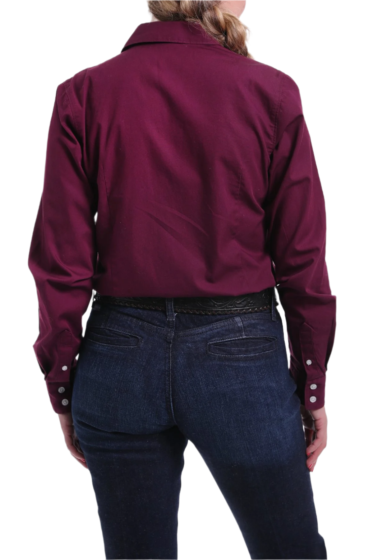 Back view of a woman wearing a burgundy button down shirt with jeans and a western belt