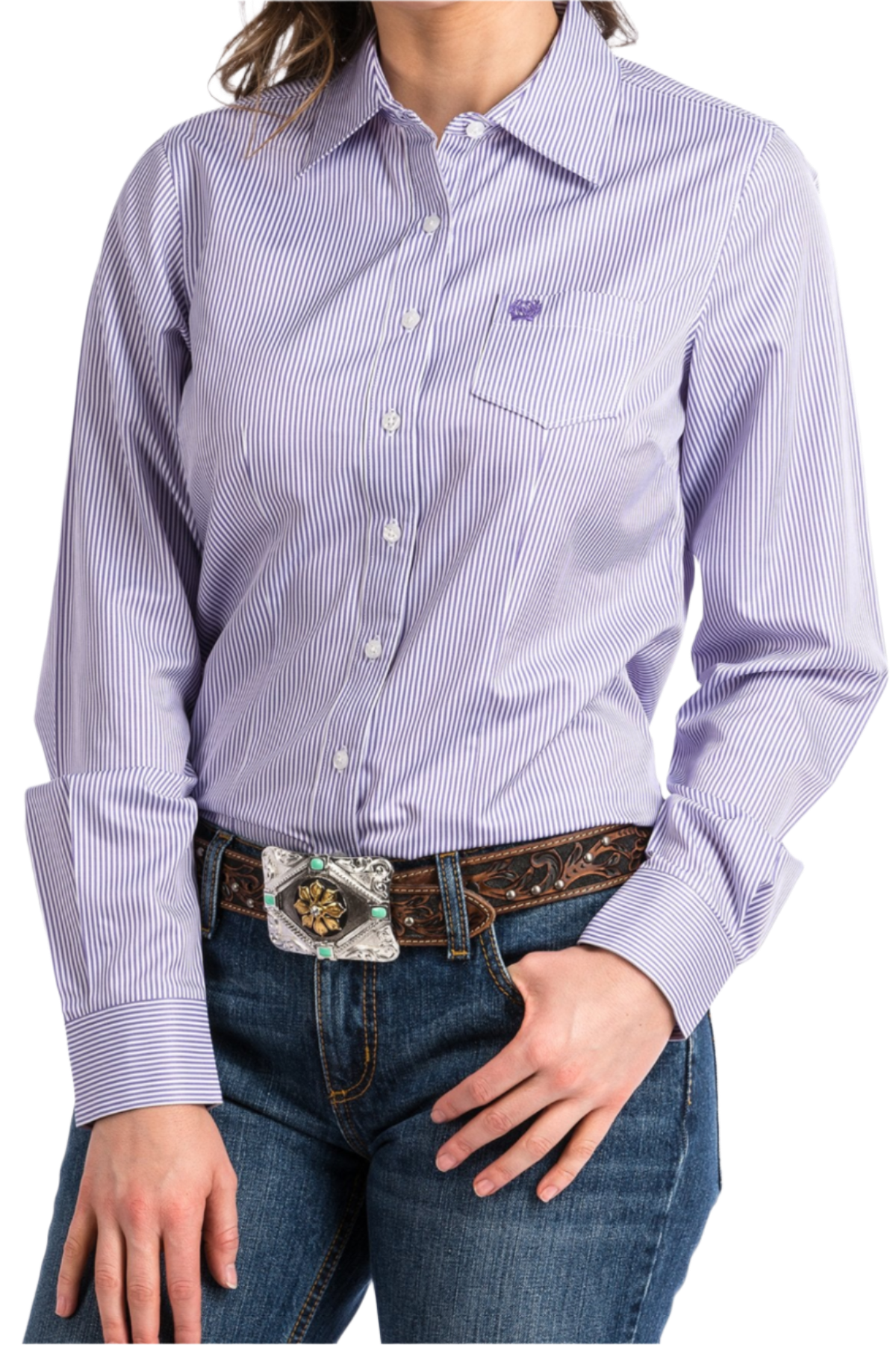 Woman wearing a purple button down shirt with jeans and a western belt