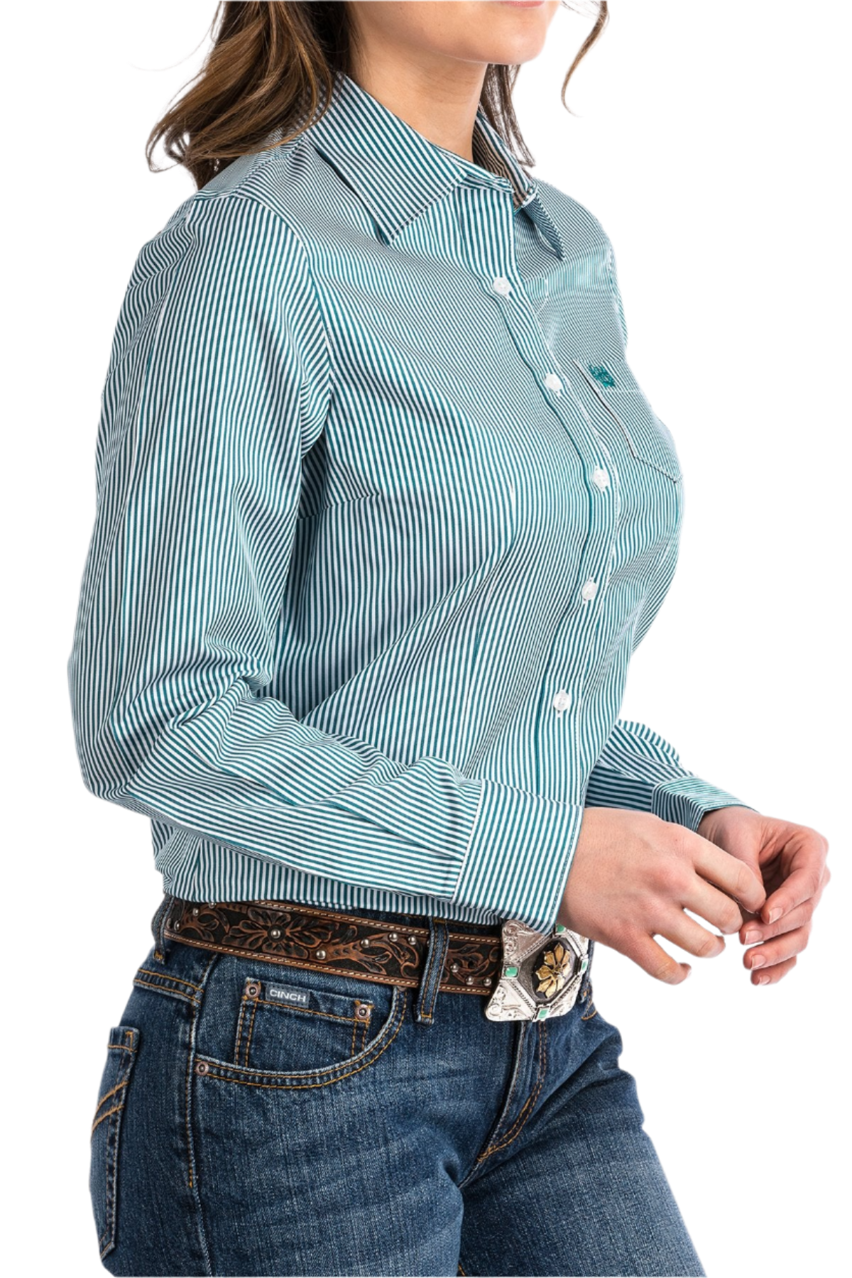 Woman wearing a striped teal button down shirt with jeans and a western belt
