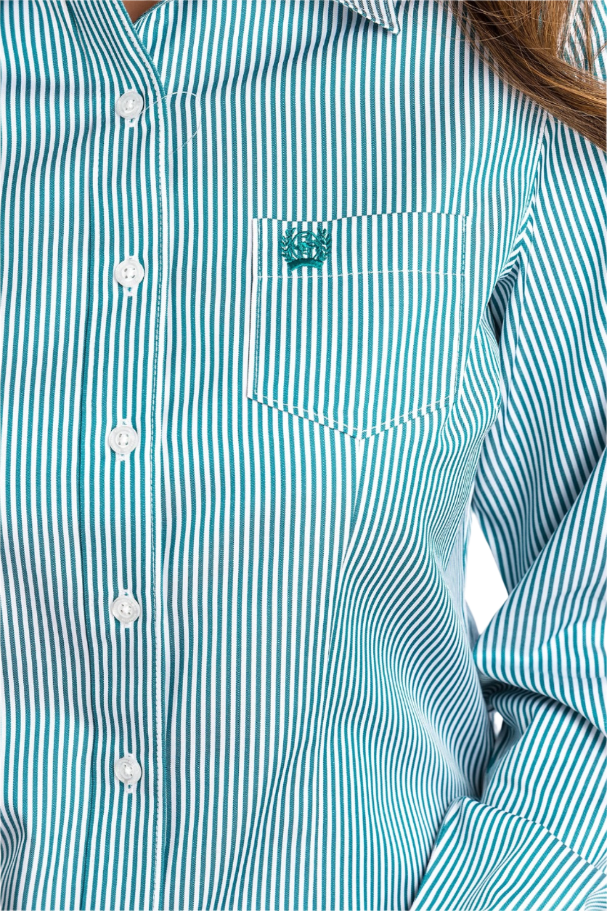 Close-up of a woman wearing a striped teal button down shirt