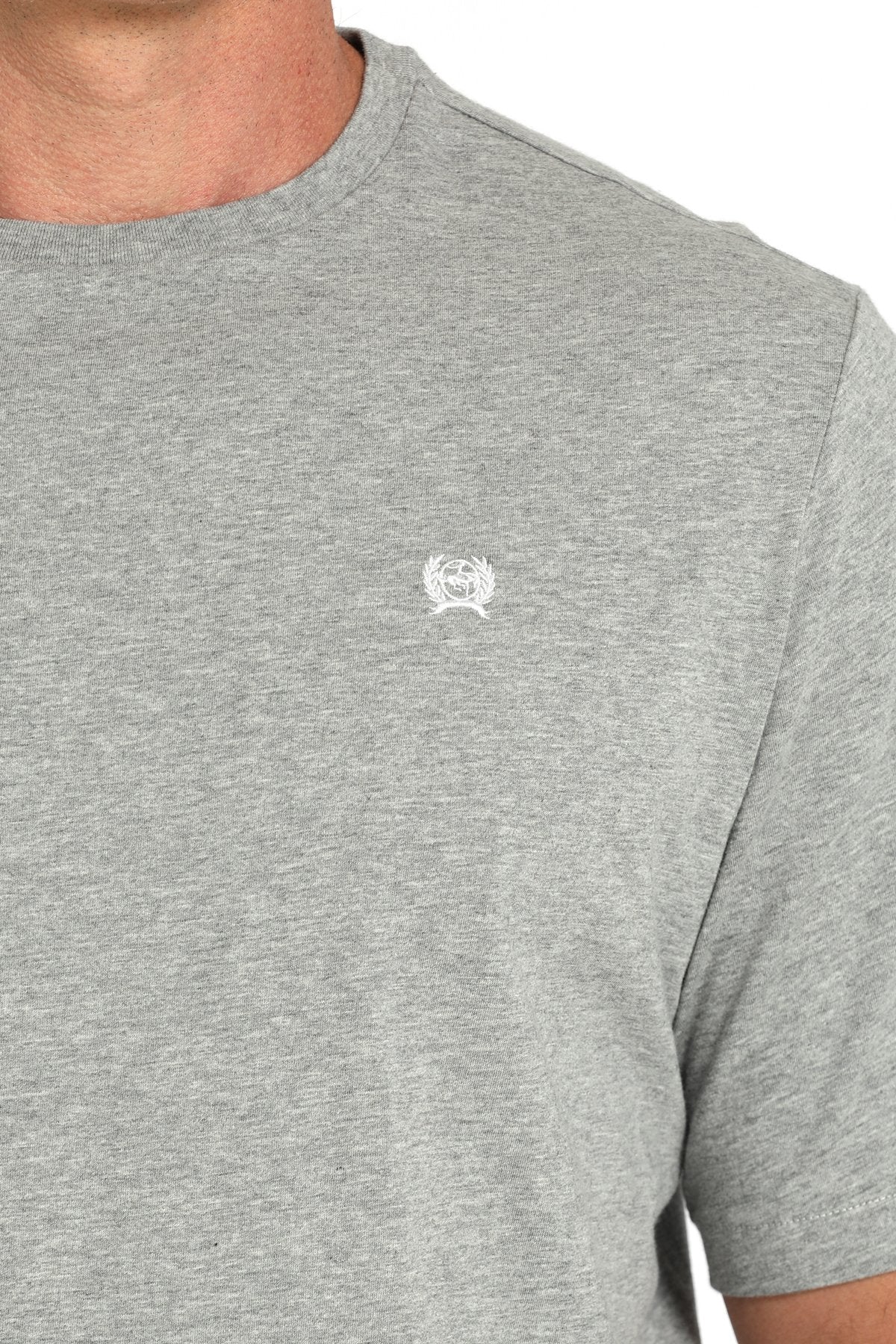Close-up view of a gray short-sleeve t-shirt with a small white chest logo displayed on a white background.