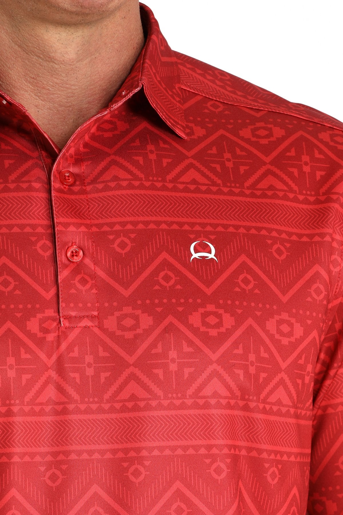 Close-up of a man wearing a red short-sleeve polo shirt with a subtle geometric pattern displayed on a white background.