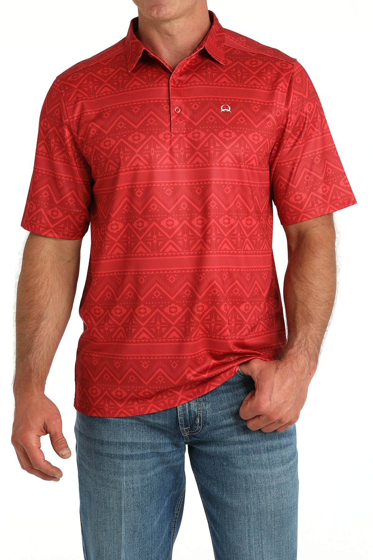 Man wearing a red short-sleeve polo shirt with a subtle geometric pattern and blue jeans displayed on a white background.