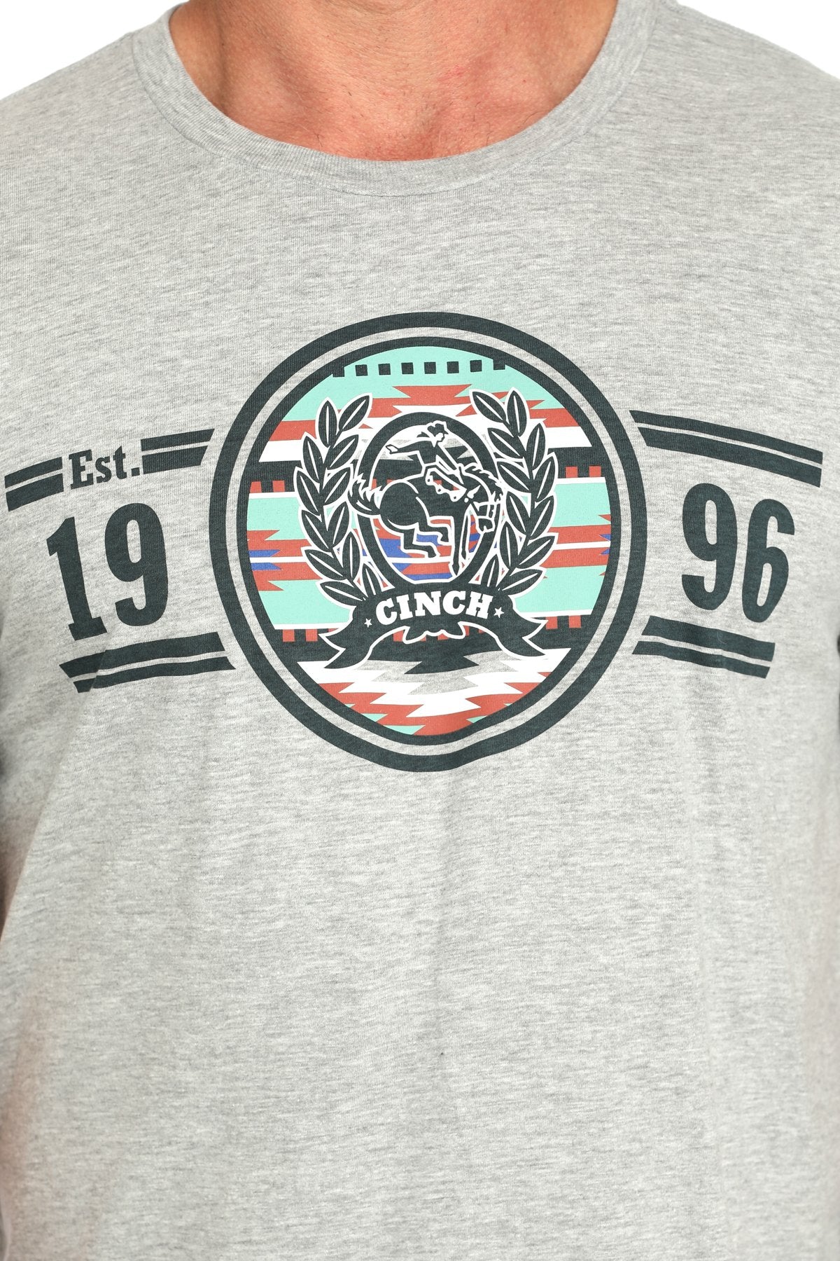 Close-up view of a gray short-sleeve t-shirt with a circular CINCH graphic and '1996' text displayed on a white background.