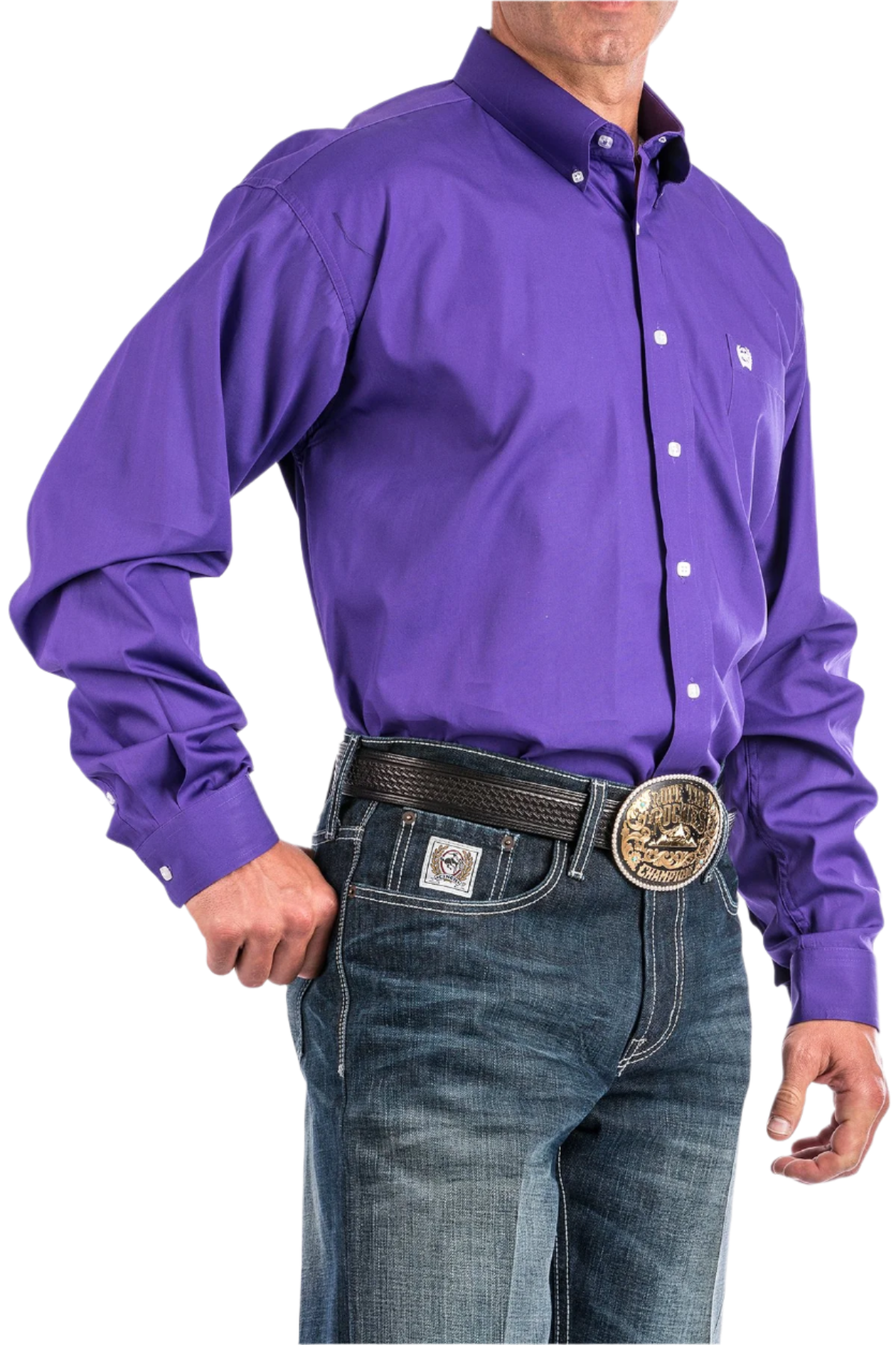 A man wearing a long-sleeve purple Western shirt with a button-down collar, paired with blue jeans and a belt with a decorative buckle.