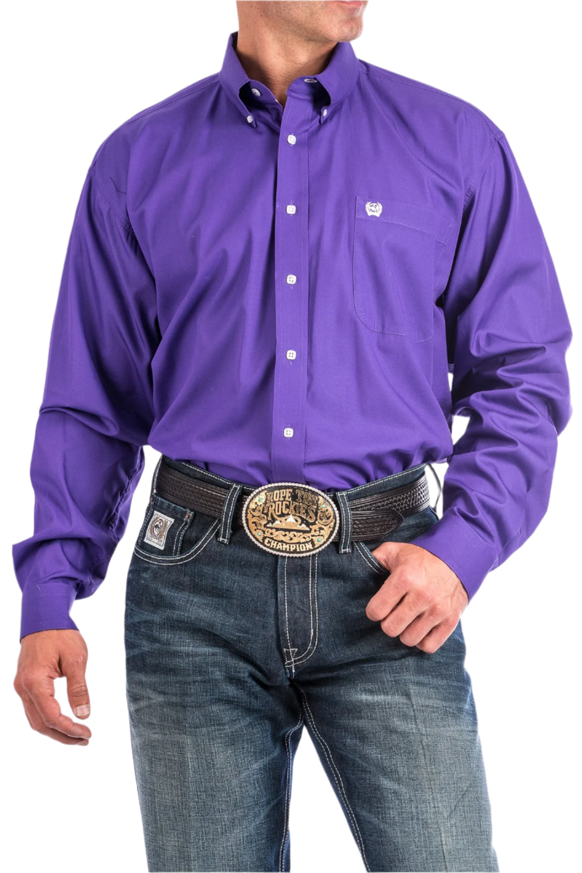 A man wearing a long-sleeve purple Western shirt with a button-down collar, paired with blue jeans and a belt with a decorative buckle.