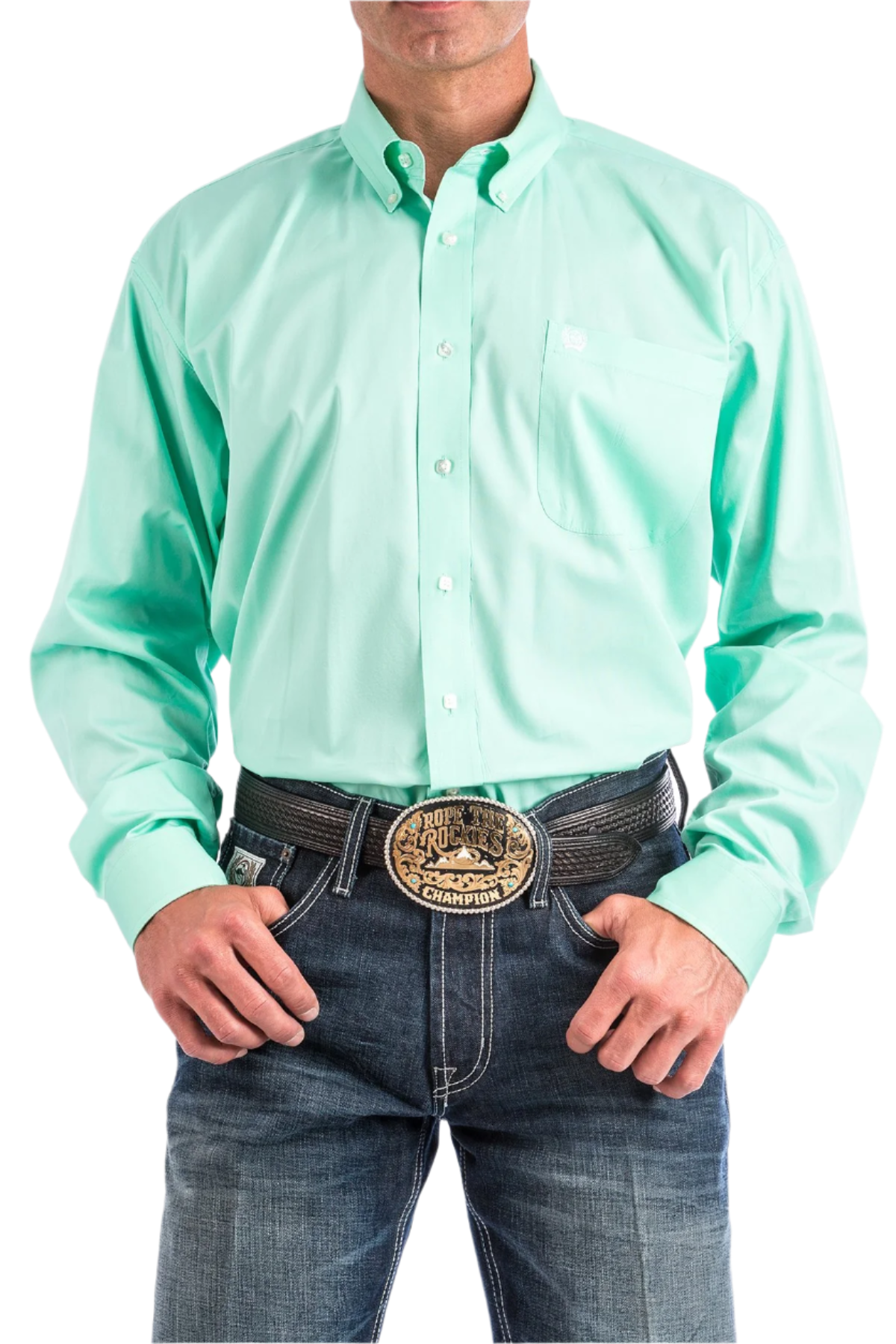 A man wearing a long-sleeve mint green Western shirt with a button-down collar, paired with blue jeans and a belt with a decorative buckle.