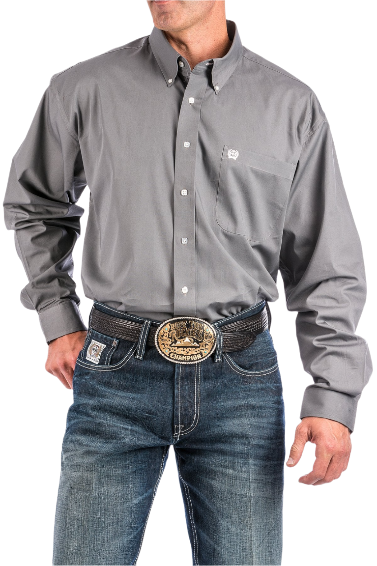 A man wearing a long-sleeve grey button-down shirt and blue jeans, with a belt and buckle visible.