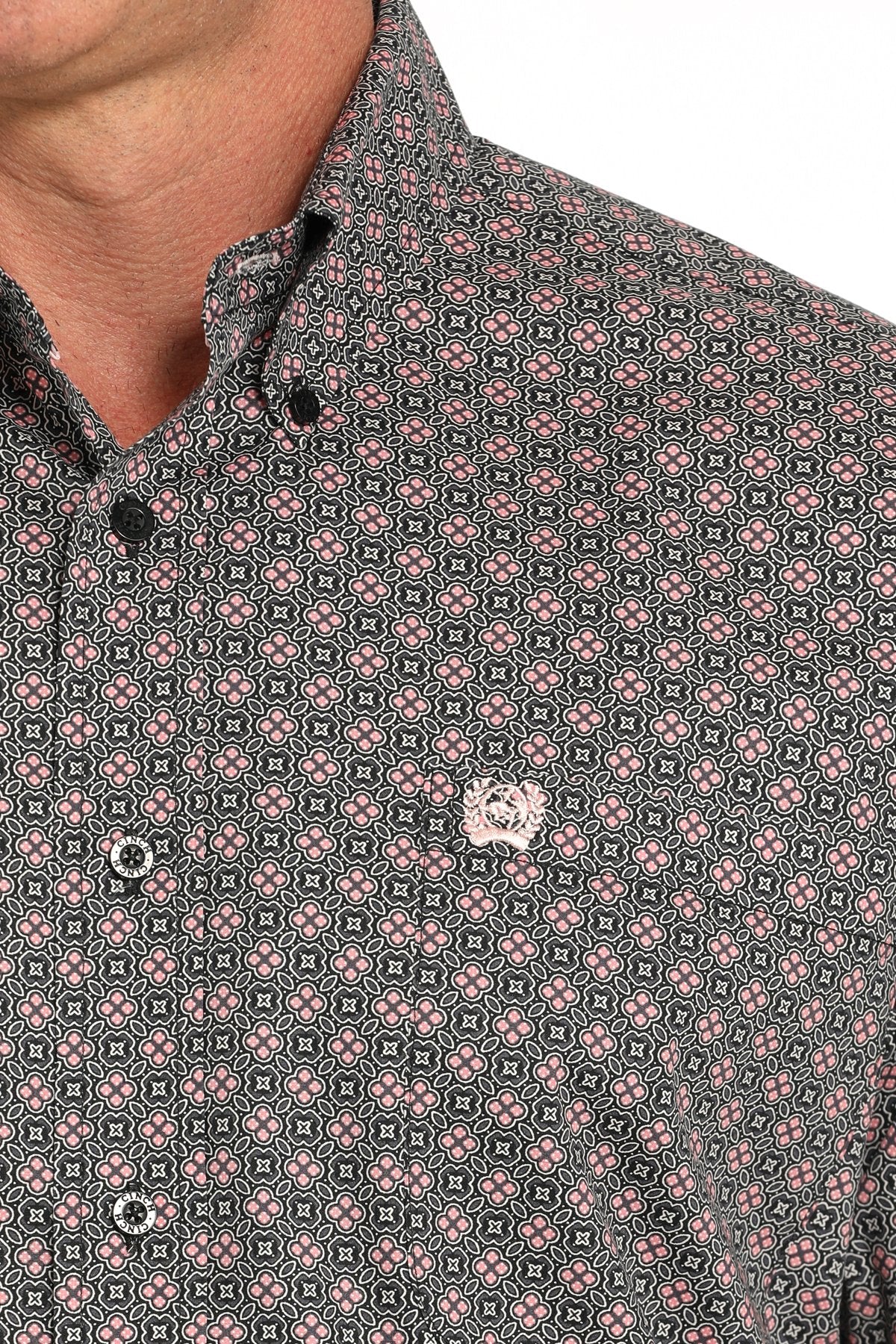 Close-up of a man wearing a gray long sleeve button-down