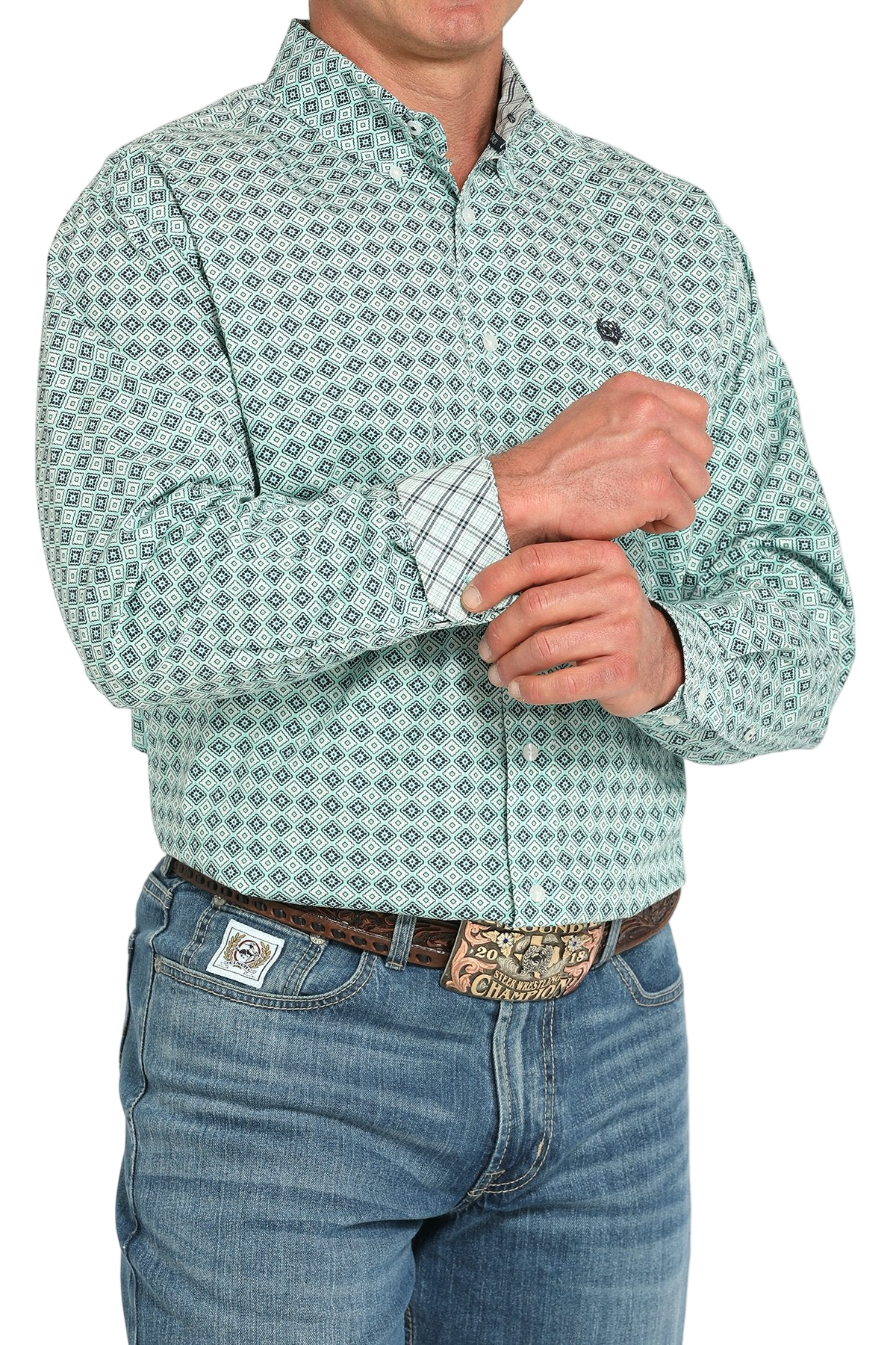 Man wearing a patterned blue long sleeve button-down shirt with contrasting cuffs and jeans on a transparent background