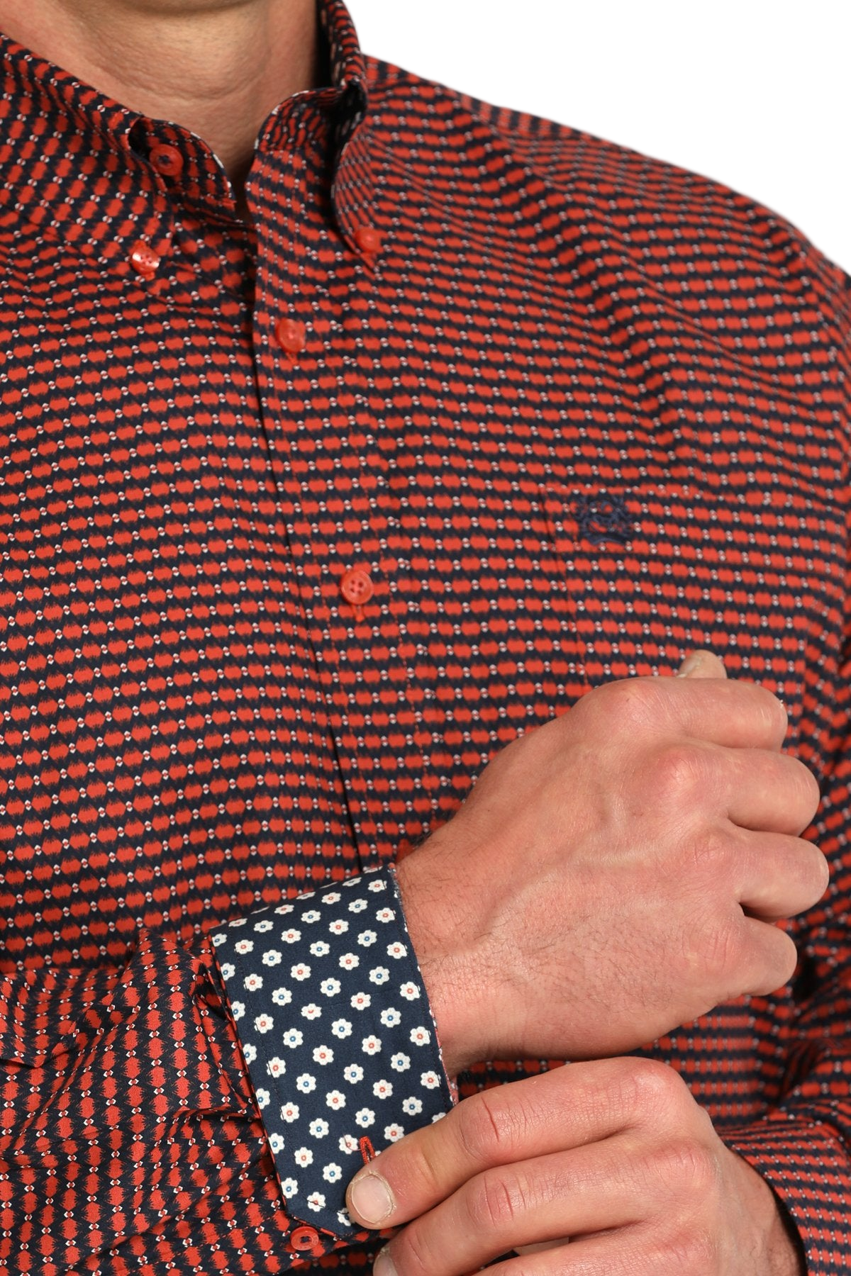 Close-up of a man wearing a patterned maroon long sleeve button-down shirt with contrasting cuffs on a transparent background