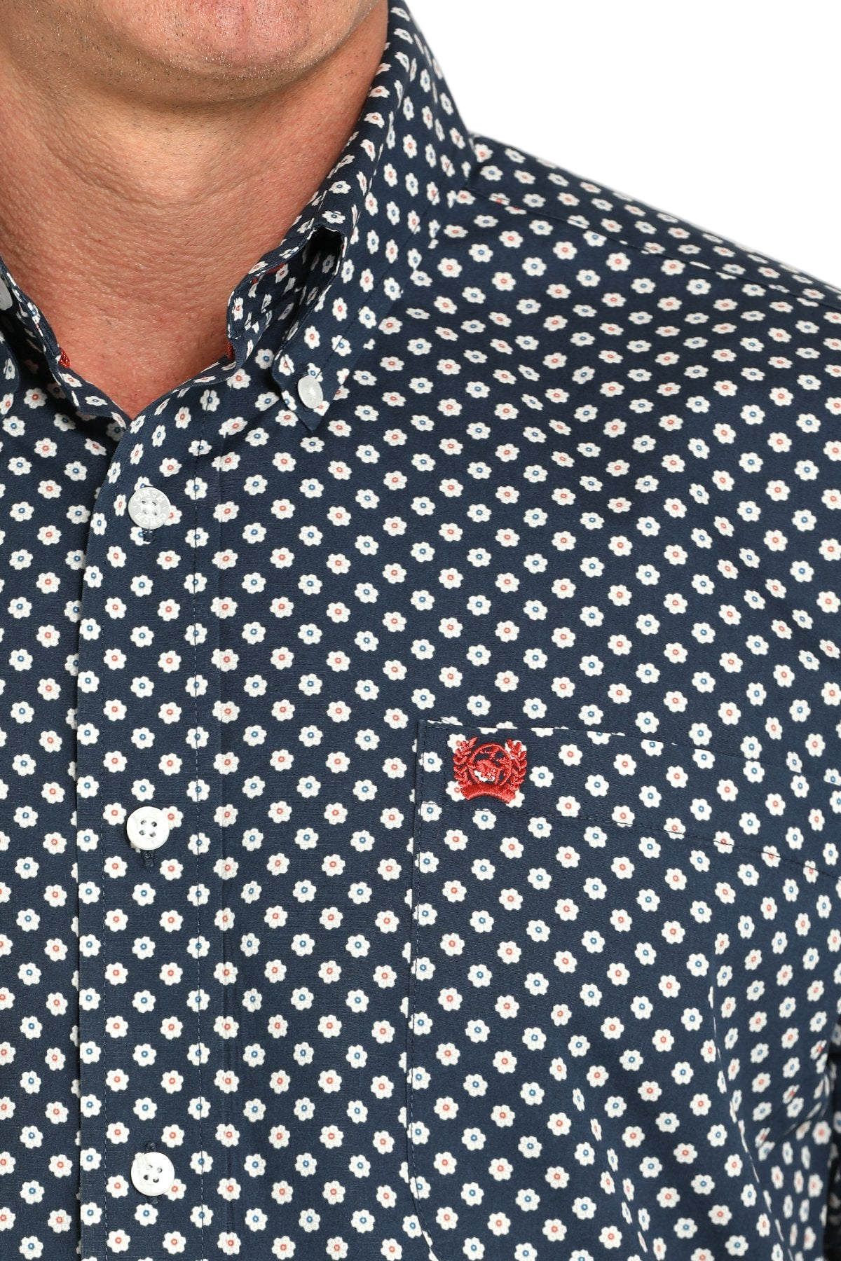 Close-up of a man wearing a patterned black long sleeve button-down shirt on a transparent background