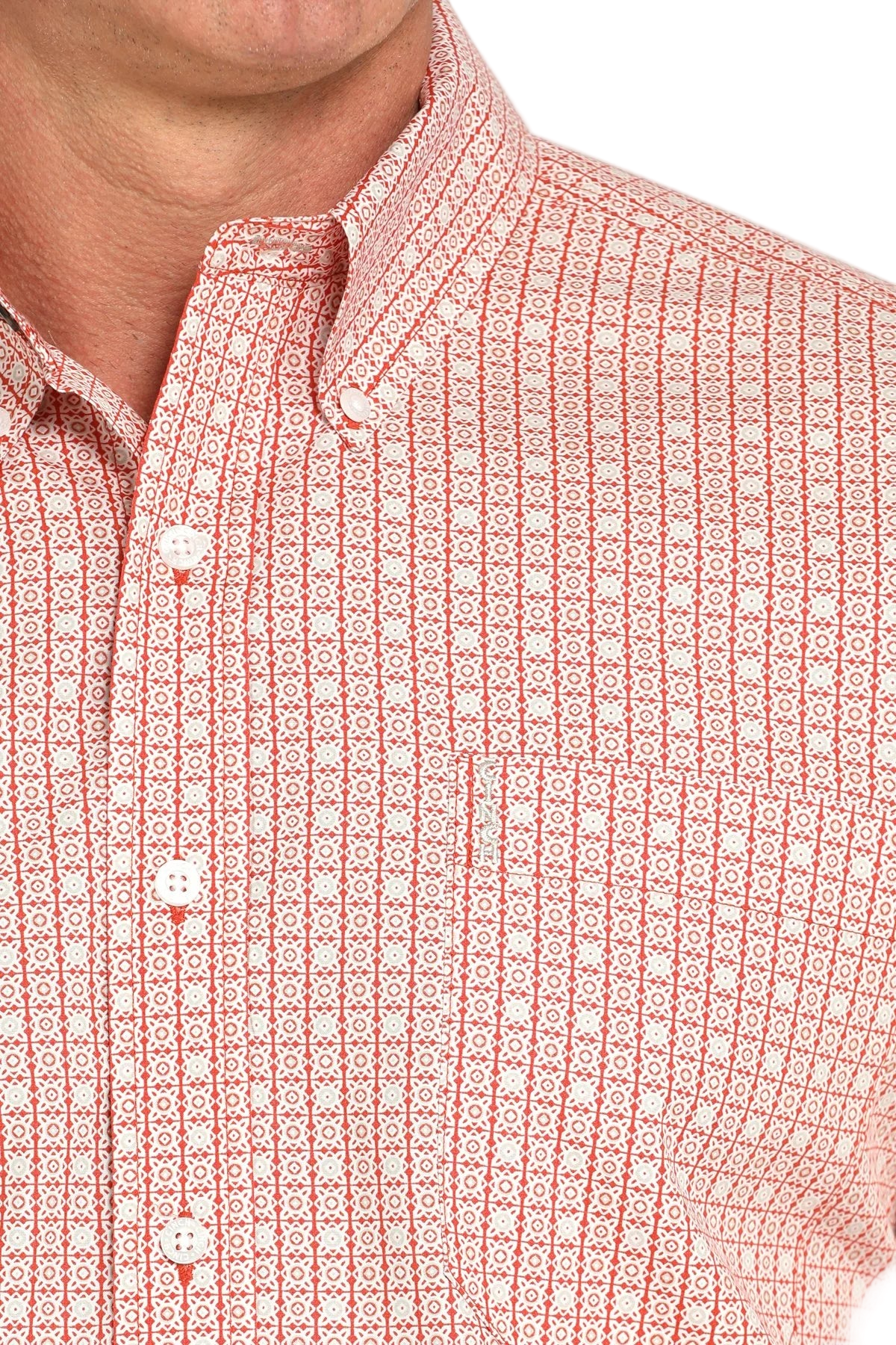 Close-up of a man wearing a patterned light pink long sleeve button-down shirt on a transparent background