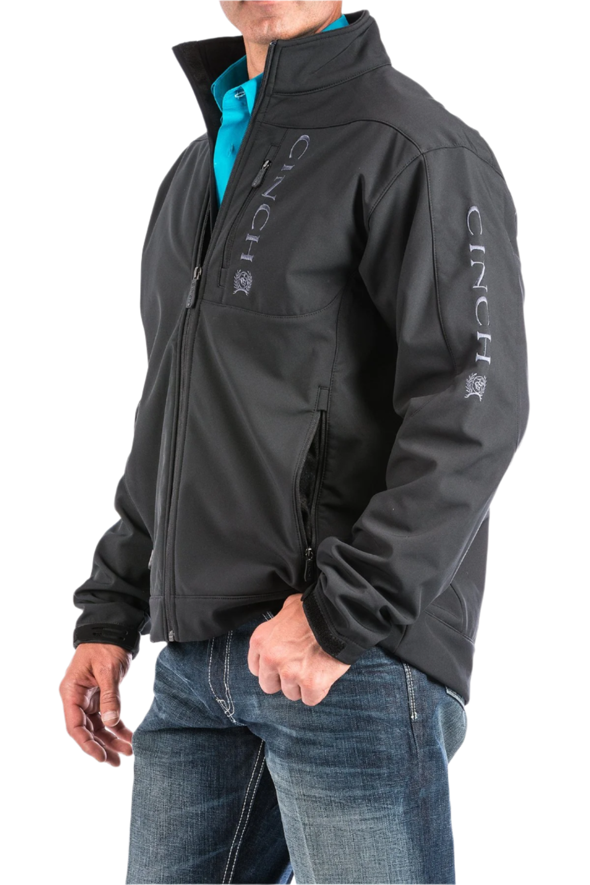 Man wearing a black jacket with the Cinch logo and jeans