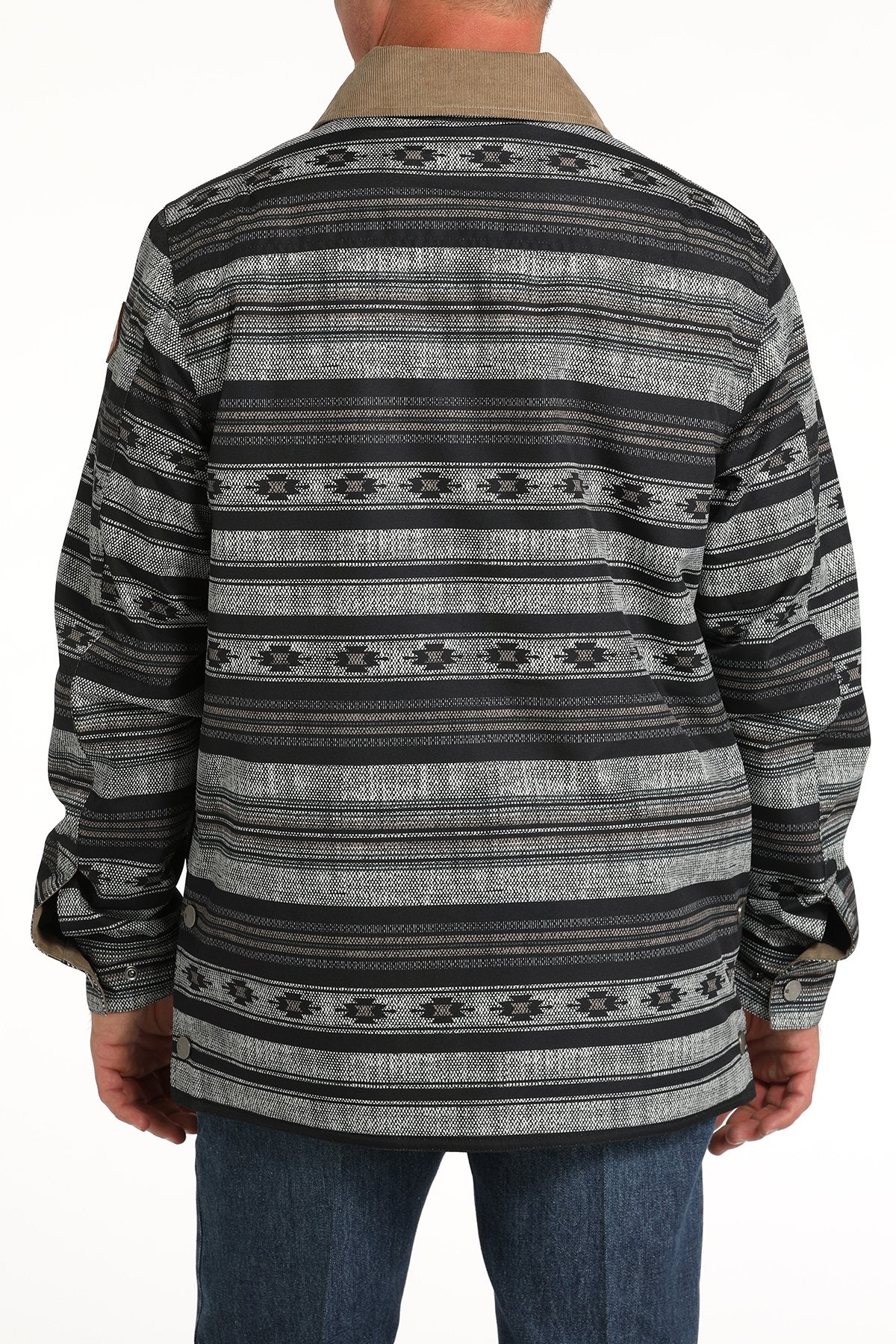 Back-view of a man wearing a black and gray patterned button-up jacket with a hood and blue jeans displayed on a white background.
