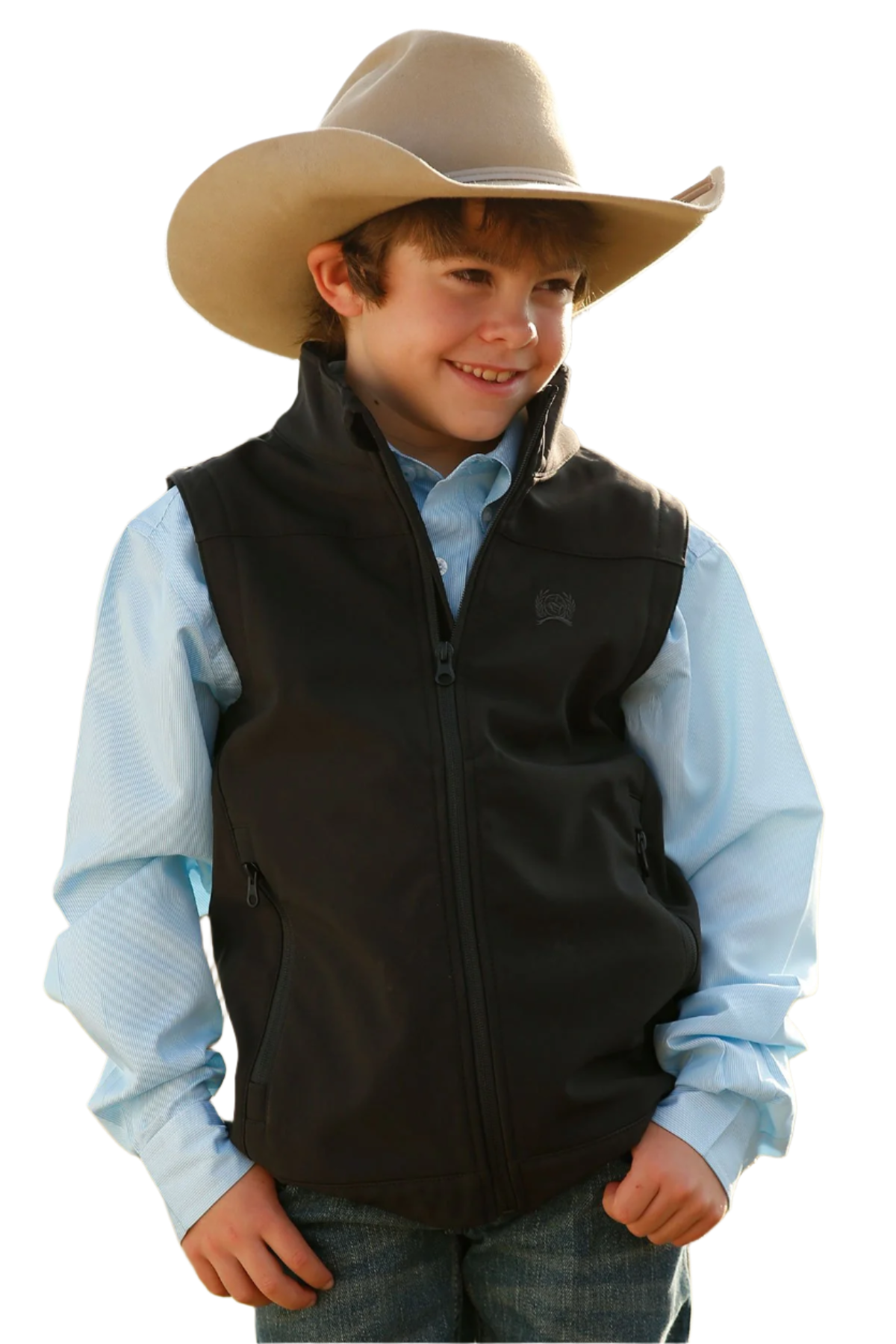 Boy wearing a black vest over a blue long sleeve shirt and jeans with a cowboy hat