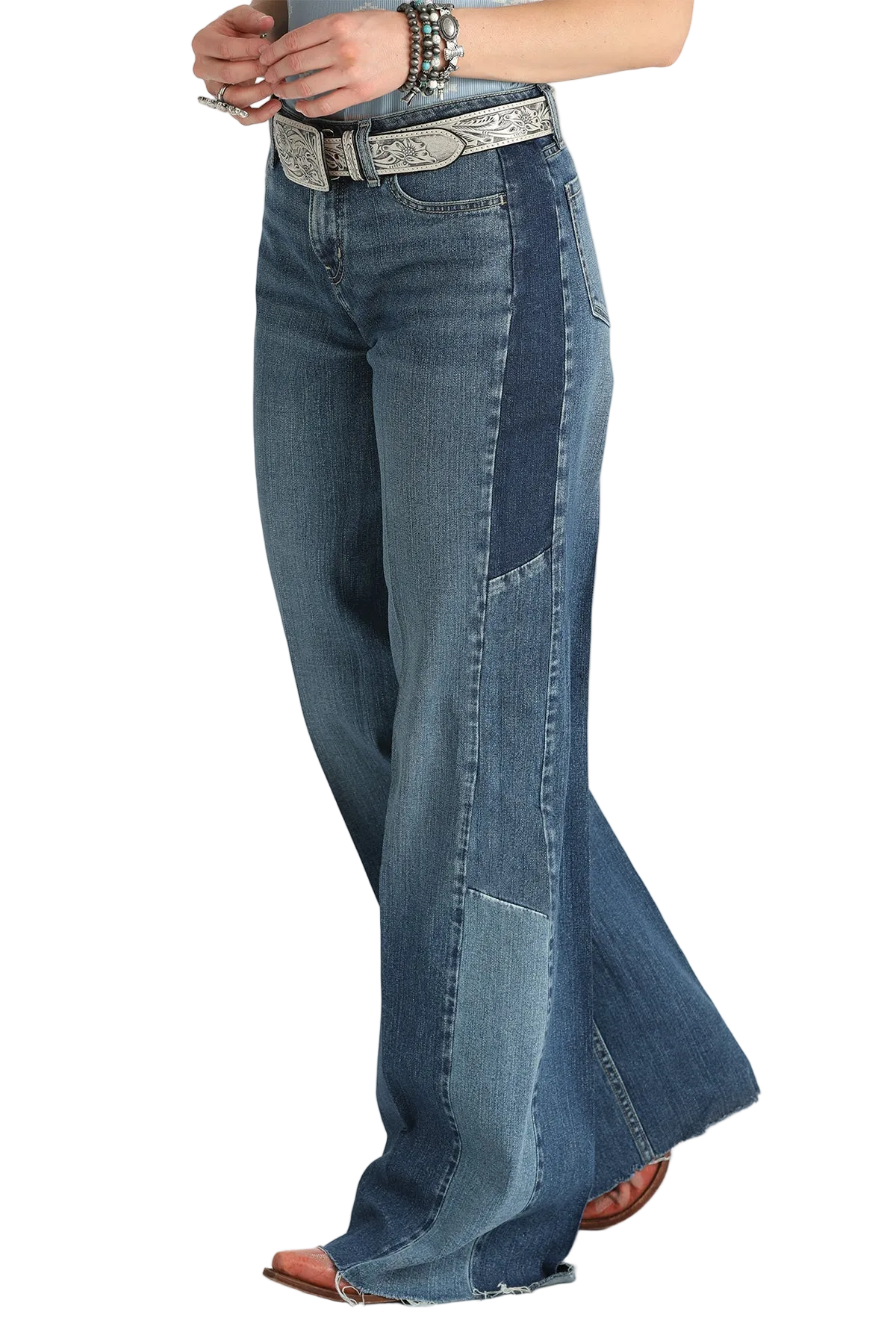Flared jeans worn by a person on a white background