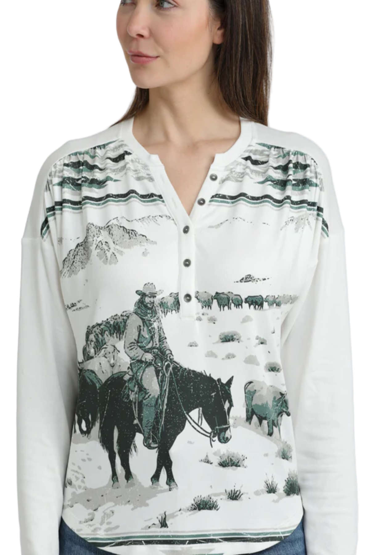 Woman wearing a white long-sleeve henley with a Western ranch scene printed across the front, featuring mountains, cattle, and a rider on horseback