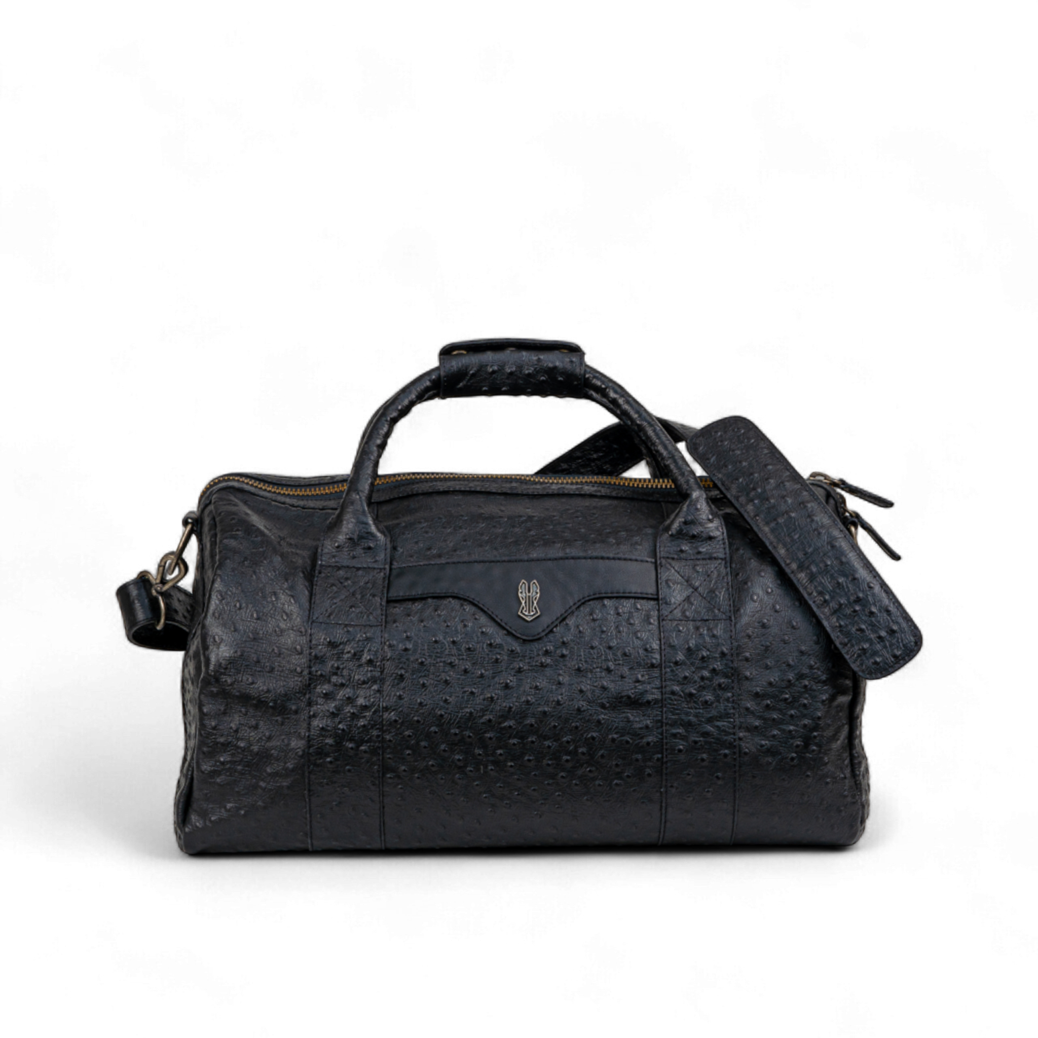 Black ostrich-print duffel bag with dual top handles, a detachable shoulder strap, and a gold zipper. A small metallic emblem is featured on the front center panel