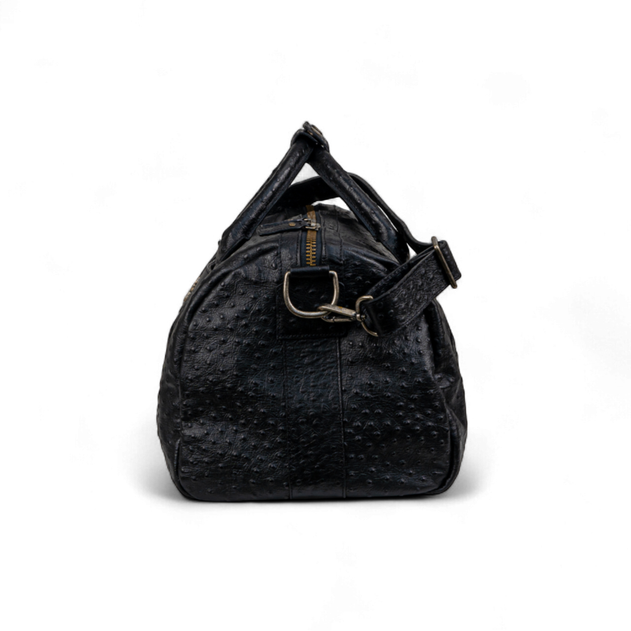 Black duffel bag shown from the side, featuring an ostrich-print texture, gold zipper, and detachable shoulder strap with metal hardware
