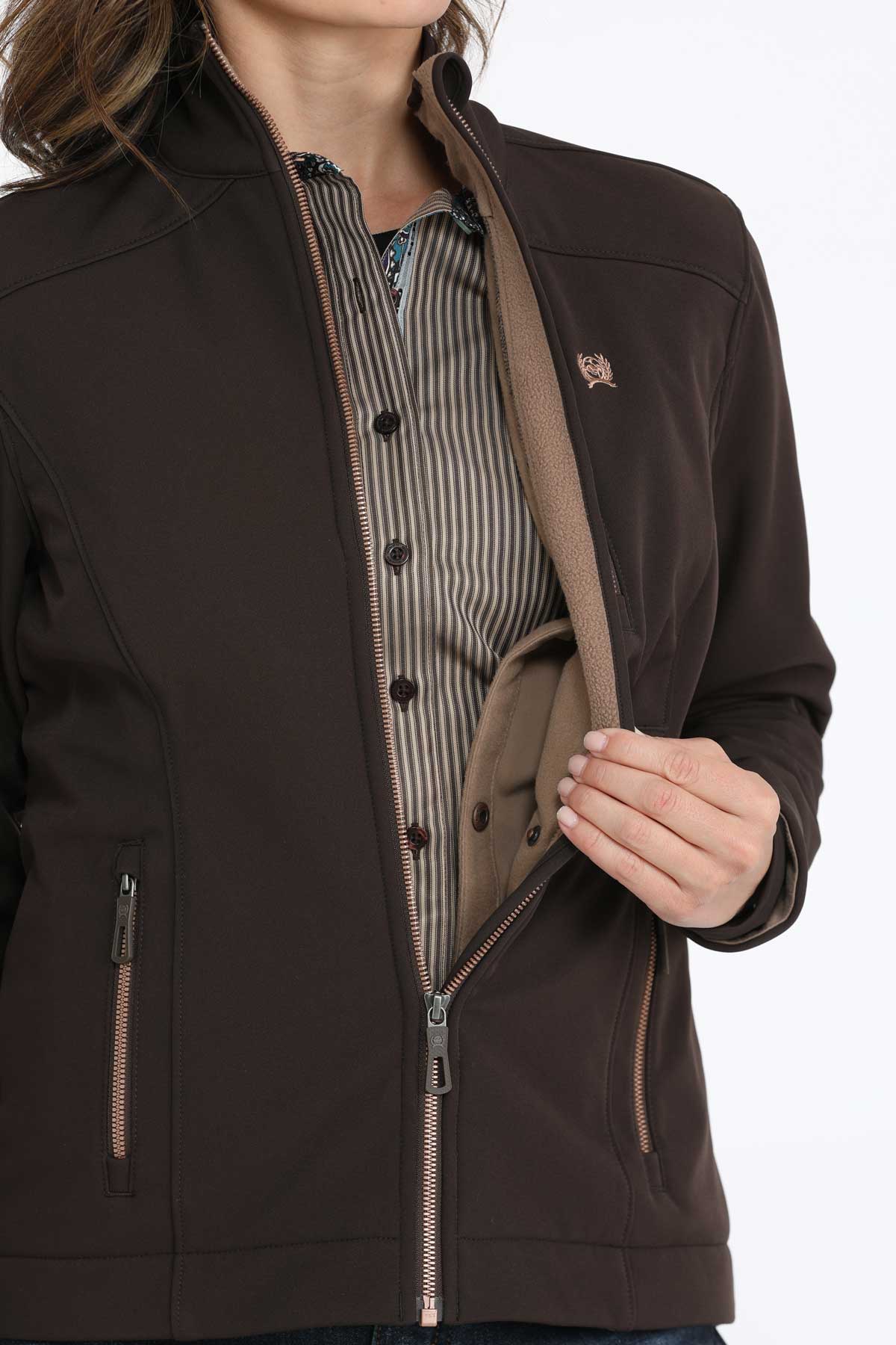 Woman wearing a brown jacket with a concealed carry pocket