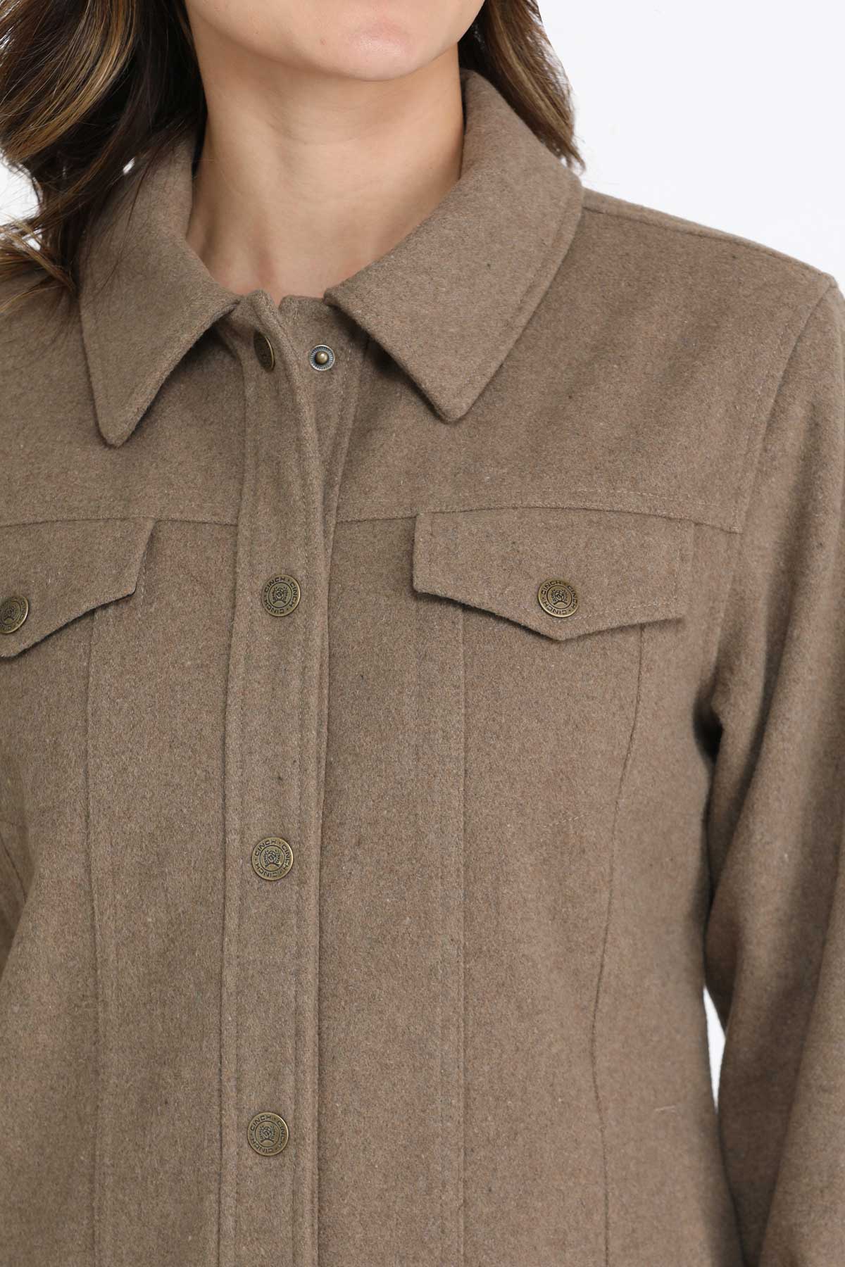 Close-up of a woman wearing a brown jacket 