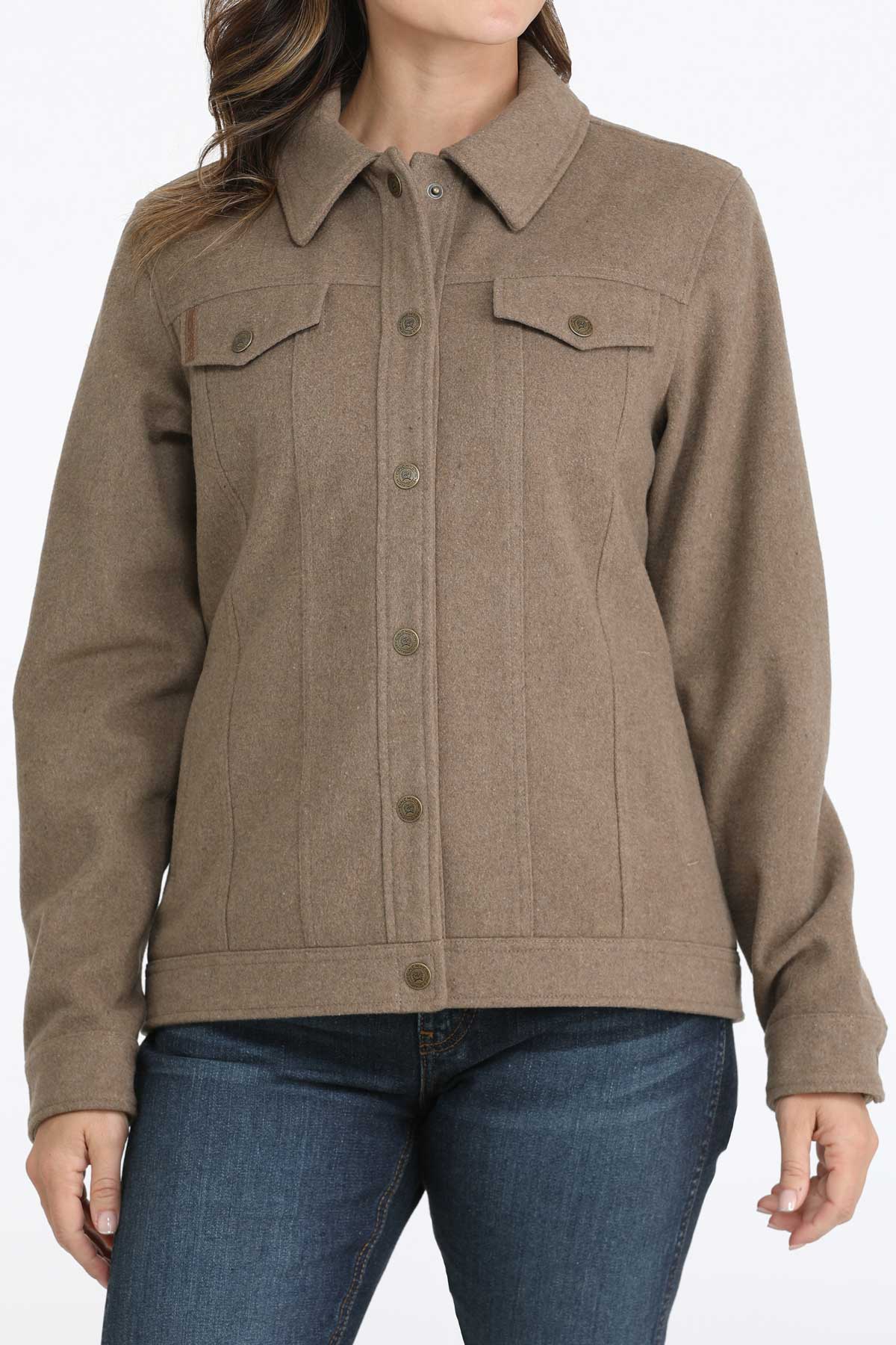Woman wearing a brown jacket with jeans 