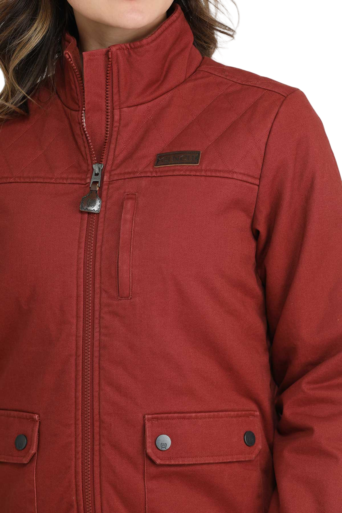 Close-up of a woman wearing a red zip-up jacket with front flap pockets 