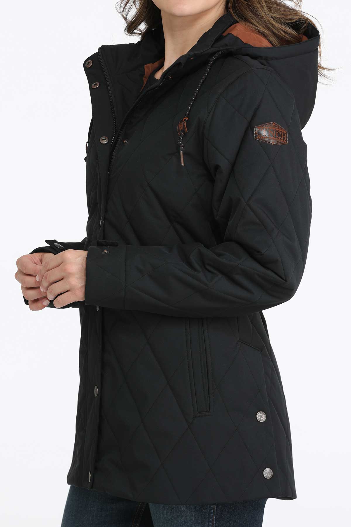 Woman wearing a black coat with jeans 