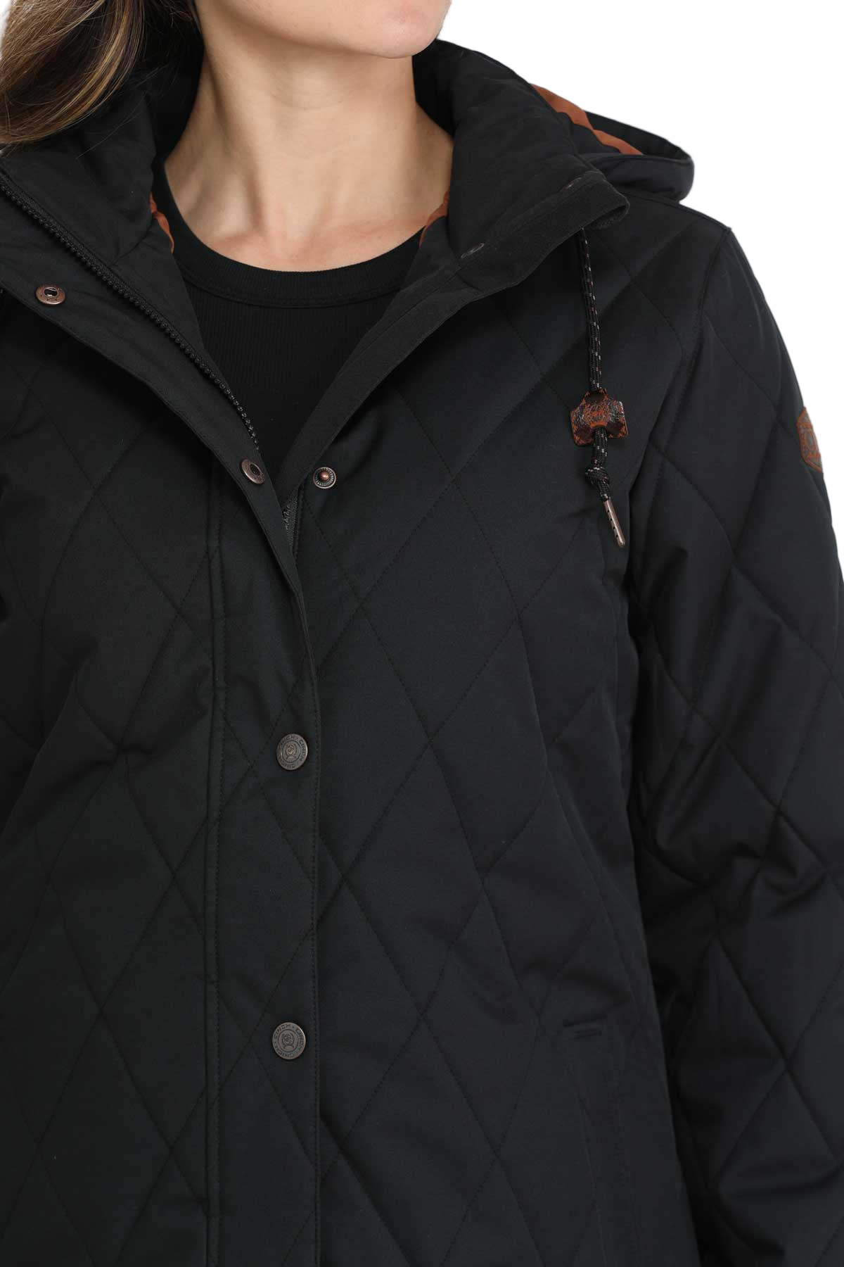 Woman wearing a long black quilted jacket with a hood