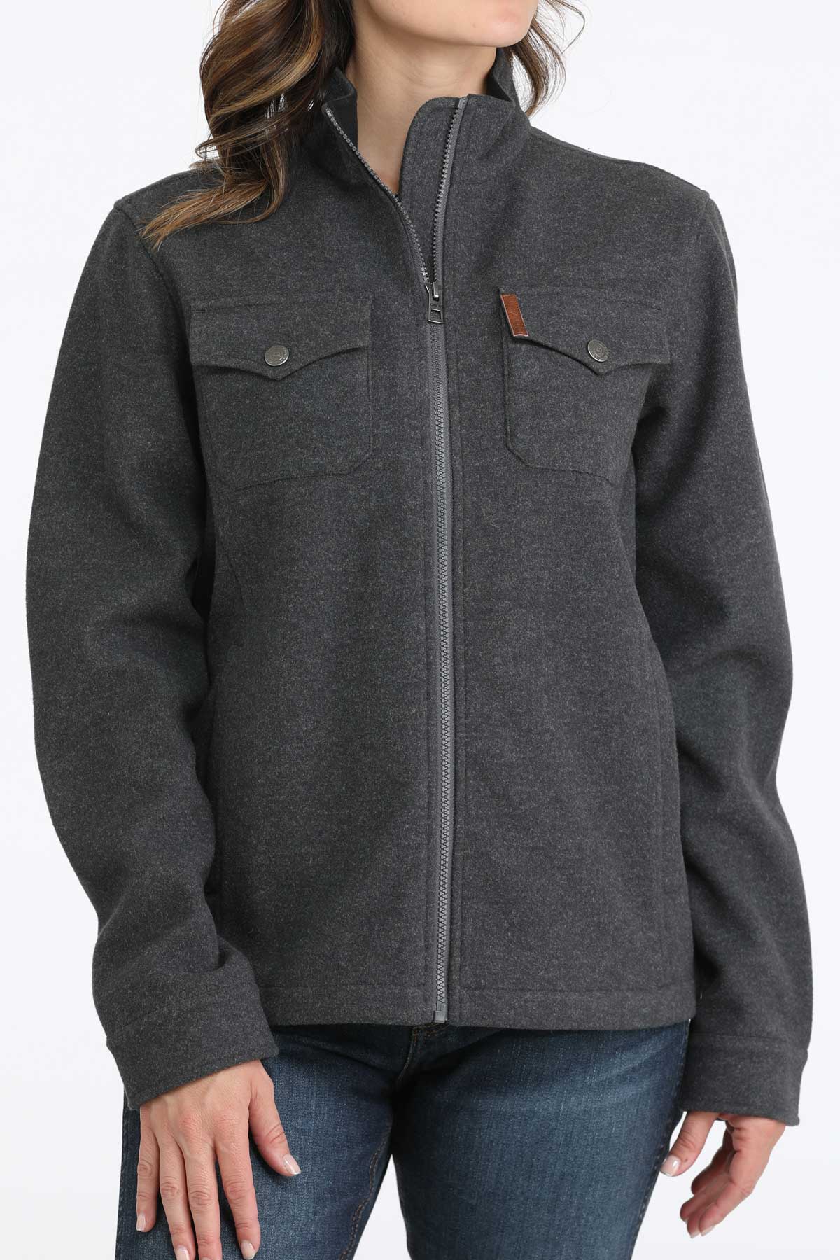 Woman wearing a gray jacket with jeans 