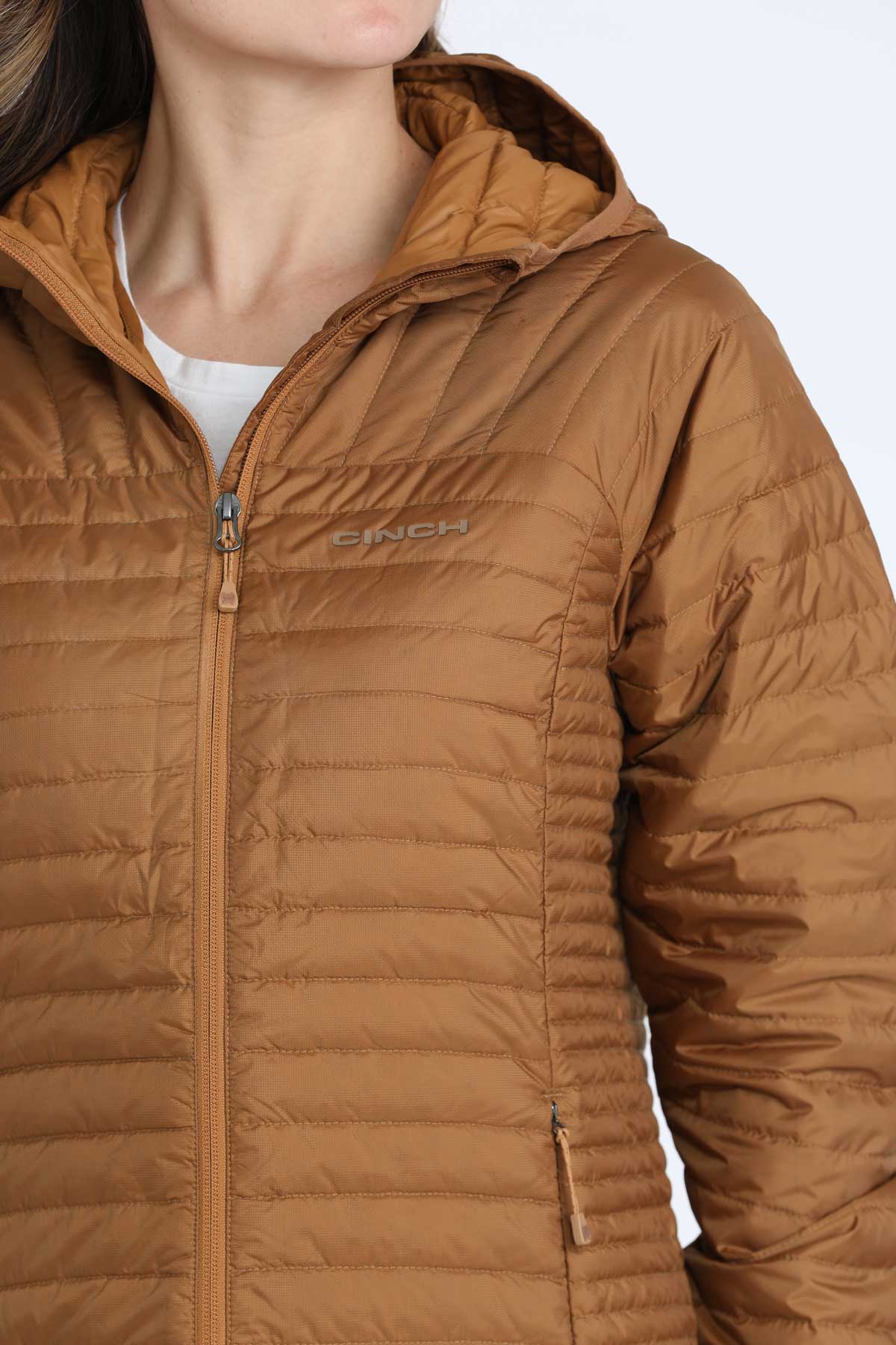 Close-up of a woman wearing a brown puffer jacket 