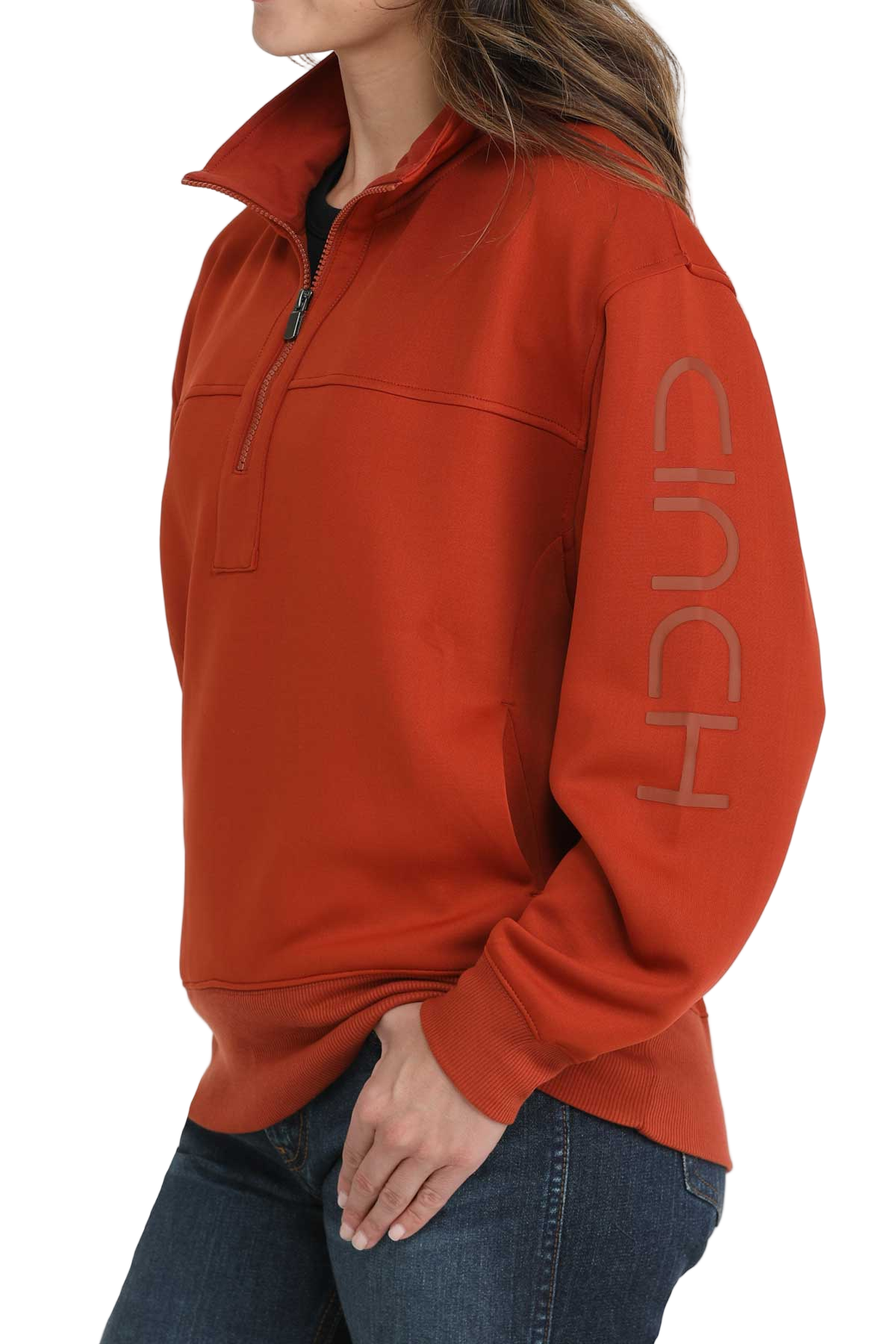 Woman wearing a red quarter-zip pullover with ribbed cuffs and hem, paired with dark-wash jeans