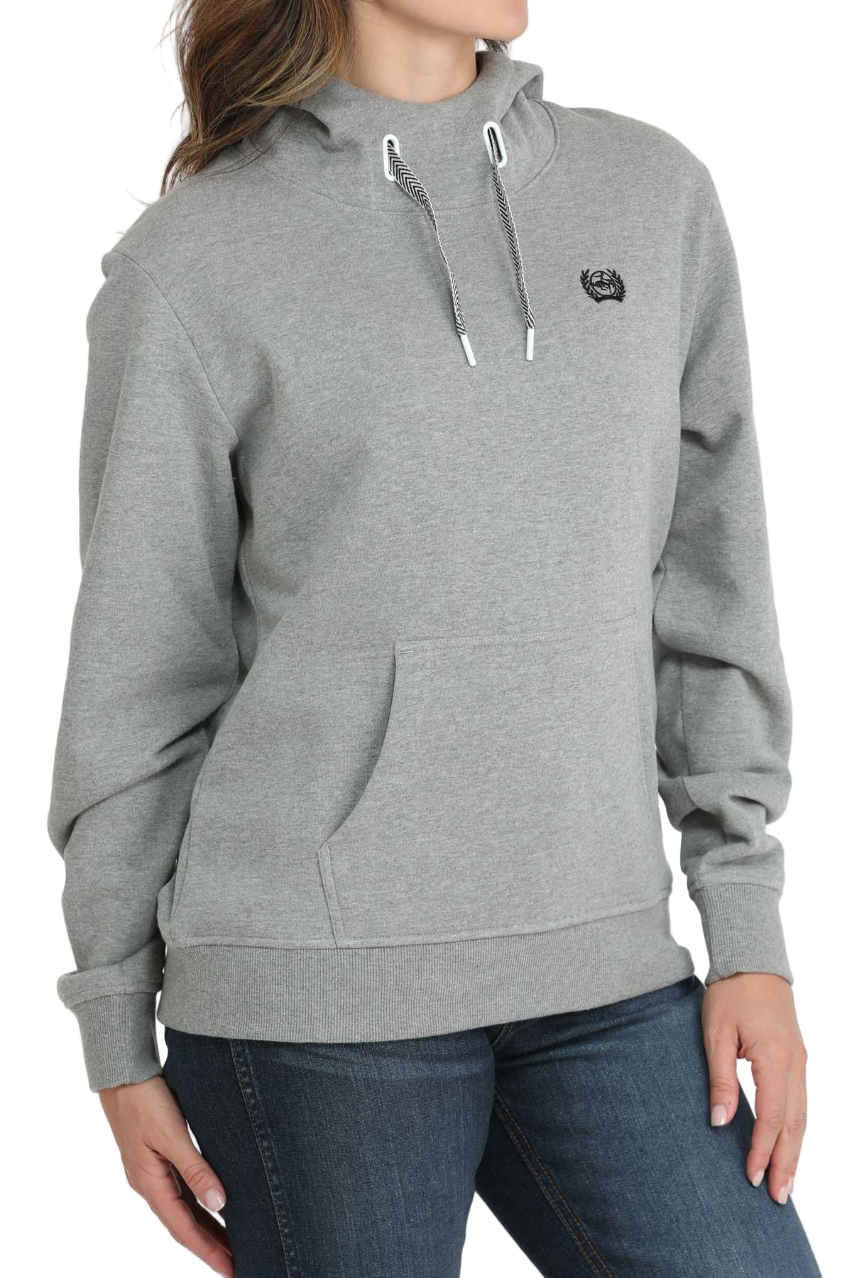 Woman wearing a light-gray hooded sweatshirt with a front pouch pocket and ribbed cuffs, paired with dark-wash jeans