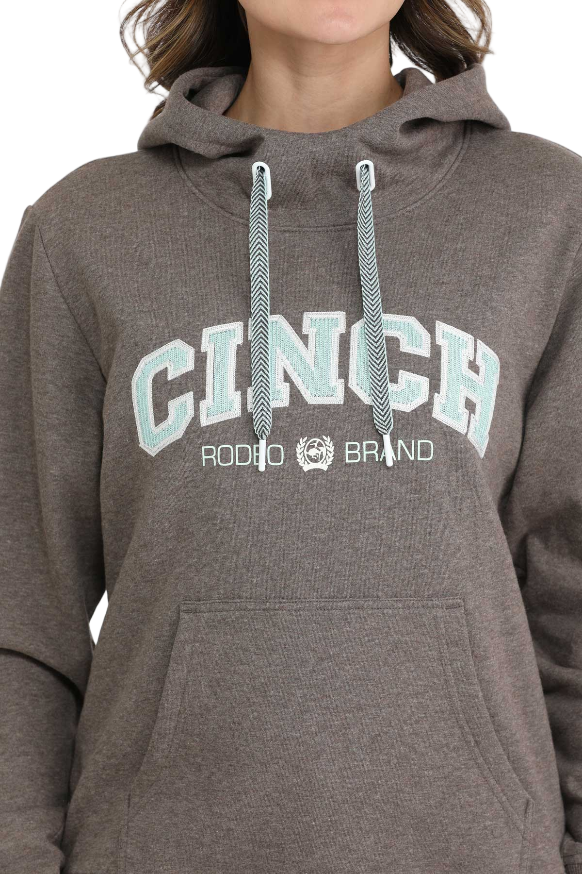 Woman wearing a brown CINCH hoodie with blue drawstrings and a front kangaroo pocket