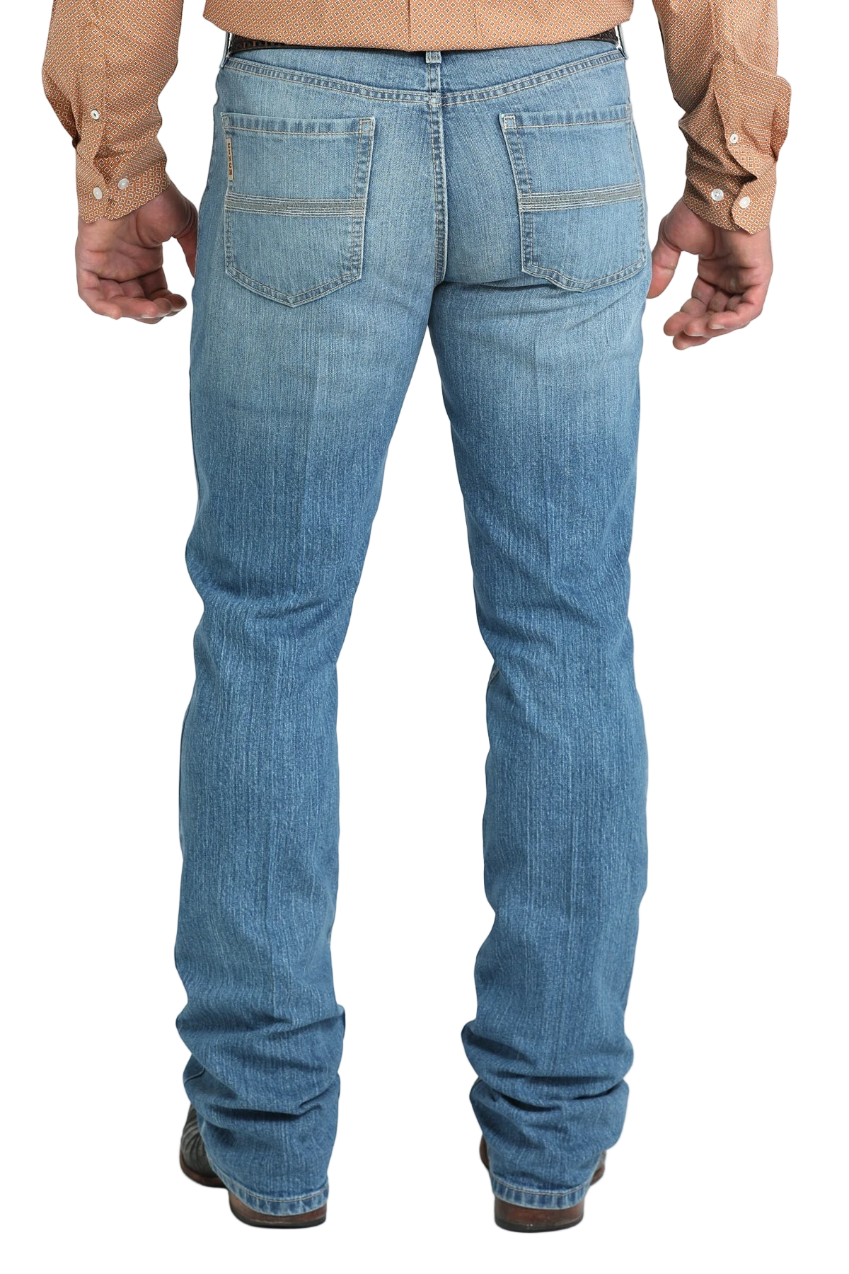 Back view of a man wearing blue denim jeans, and a belt, with a tucked-in patterned shirt