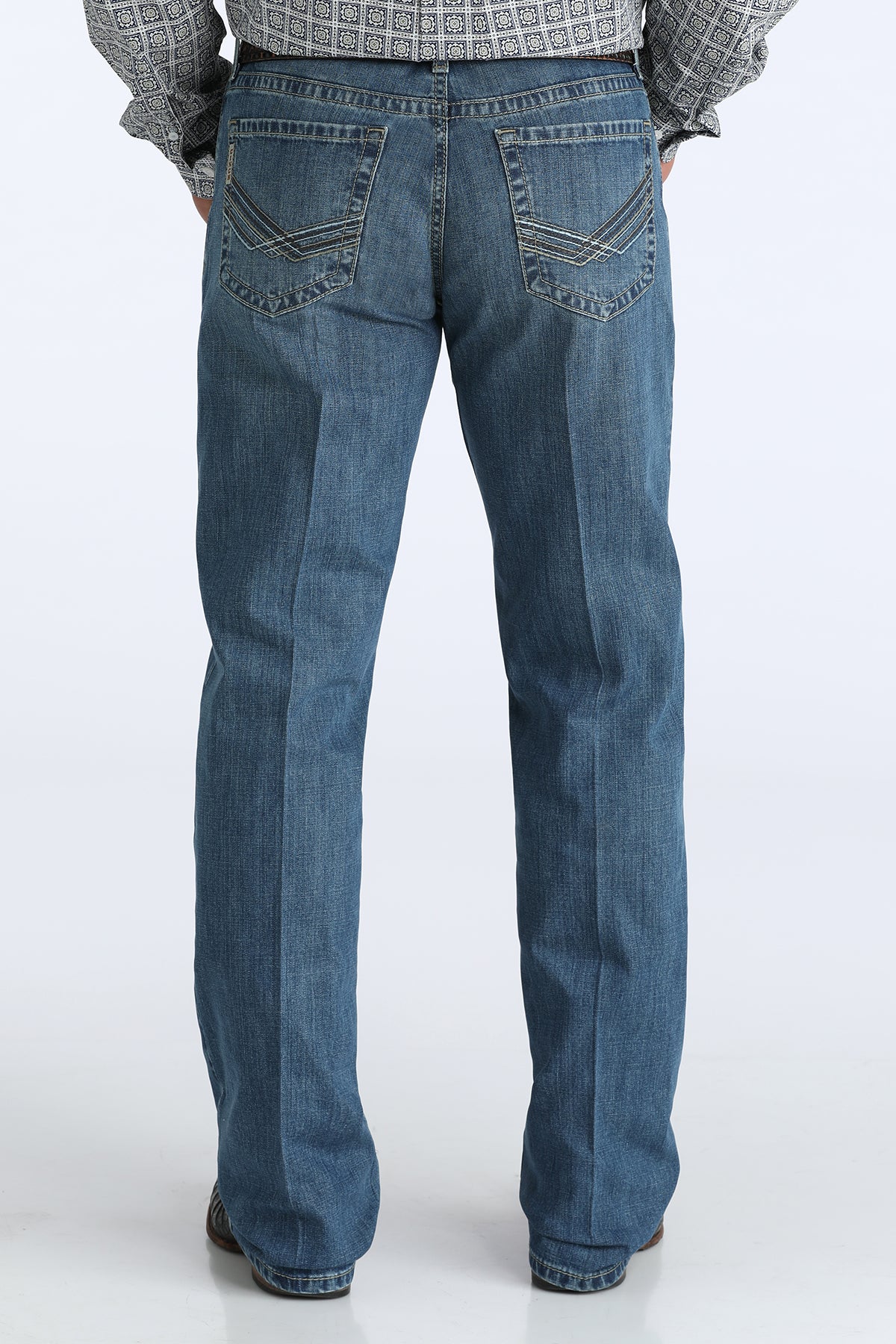 Blue jeans worn by a person on a white background