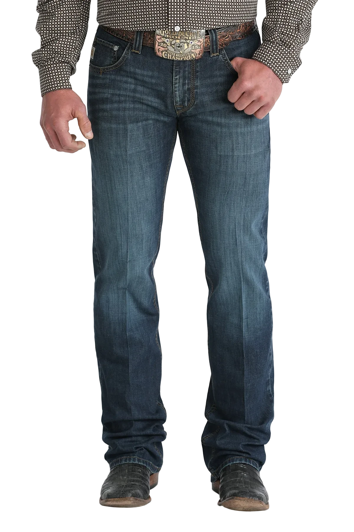 Person wearing blue jeans with a patterned shirt and belt on a white background